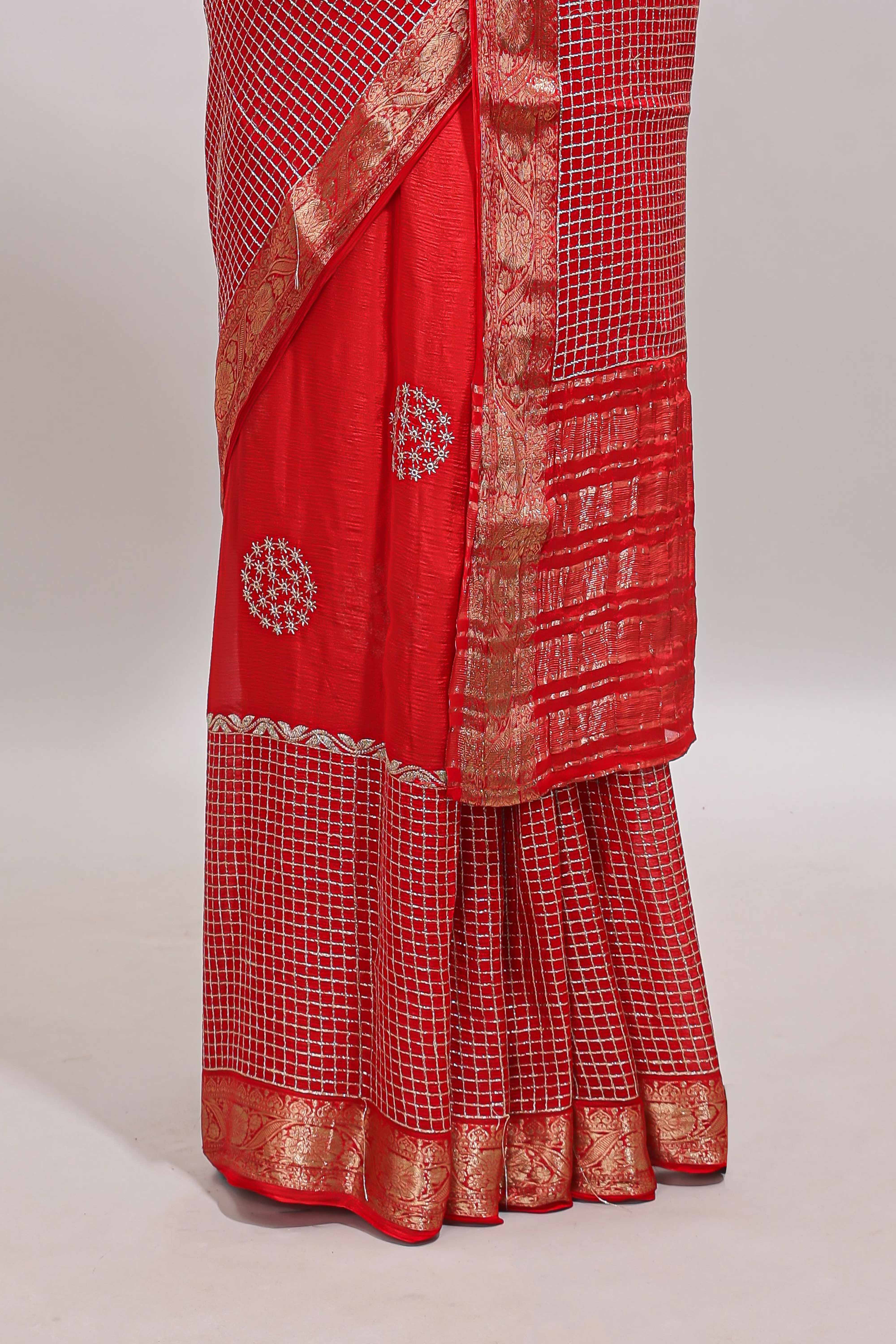 Red checked floral motifs chiffon saree with self zari border and contrast blouse