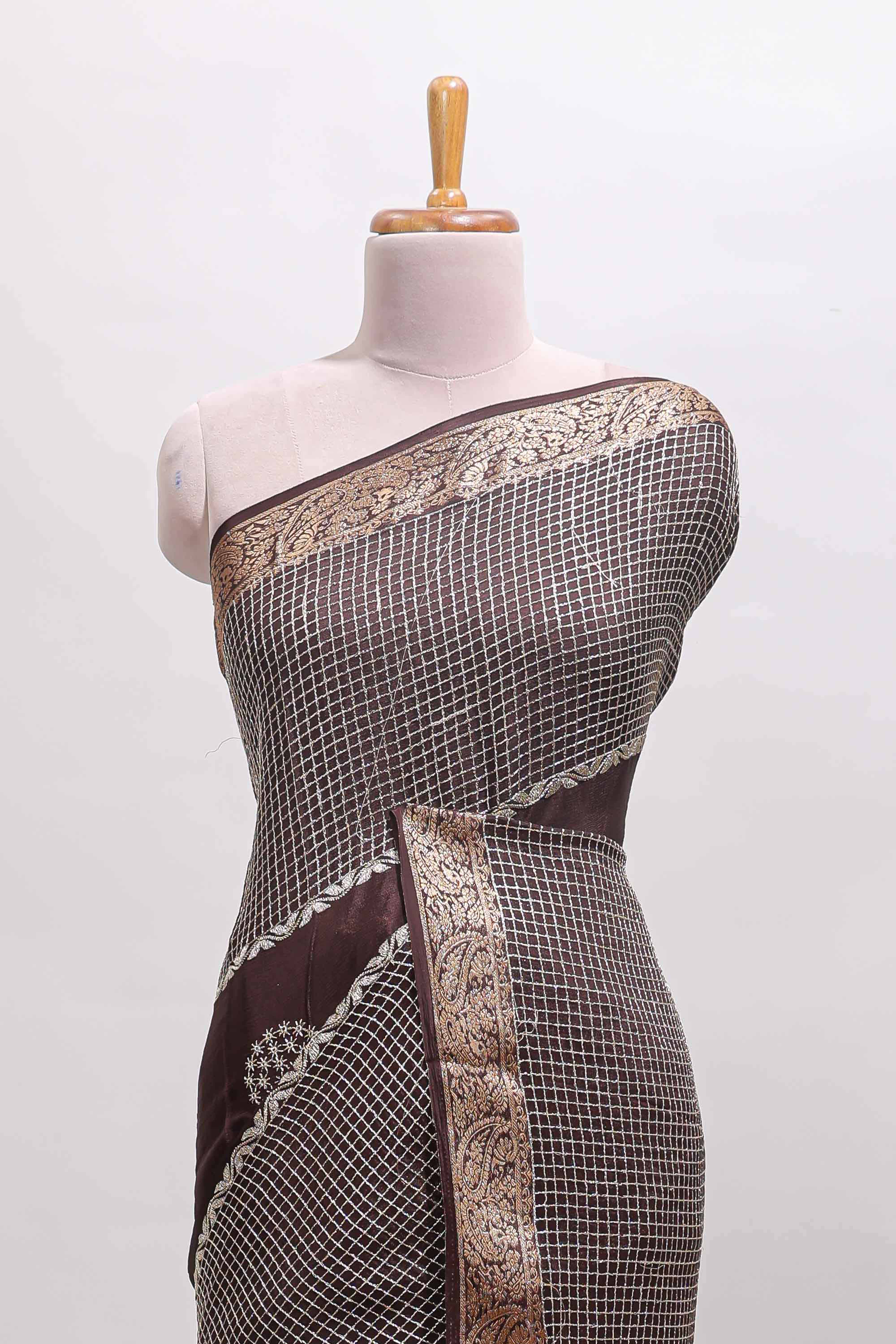 Brown checked floral motifs chiffon saree with self zari border and contrast blouse