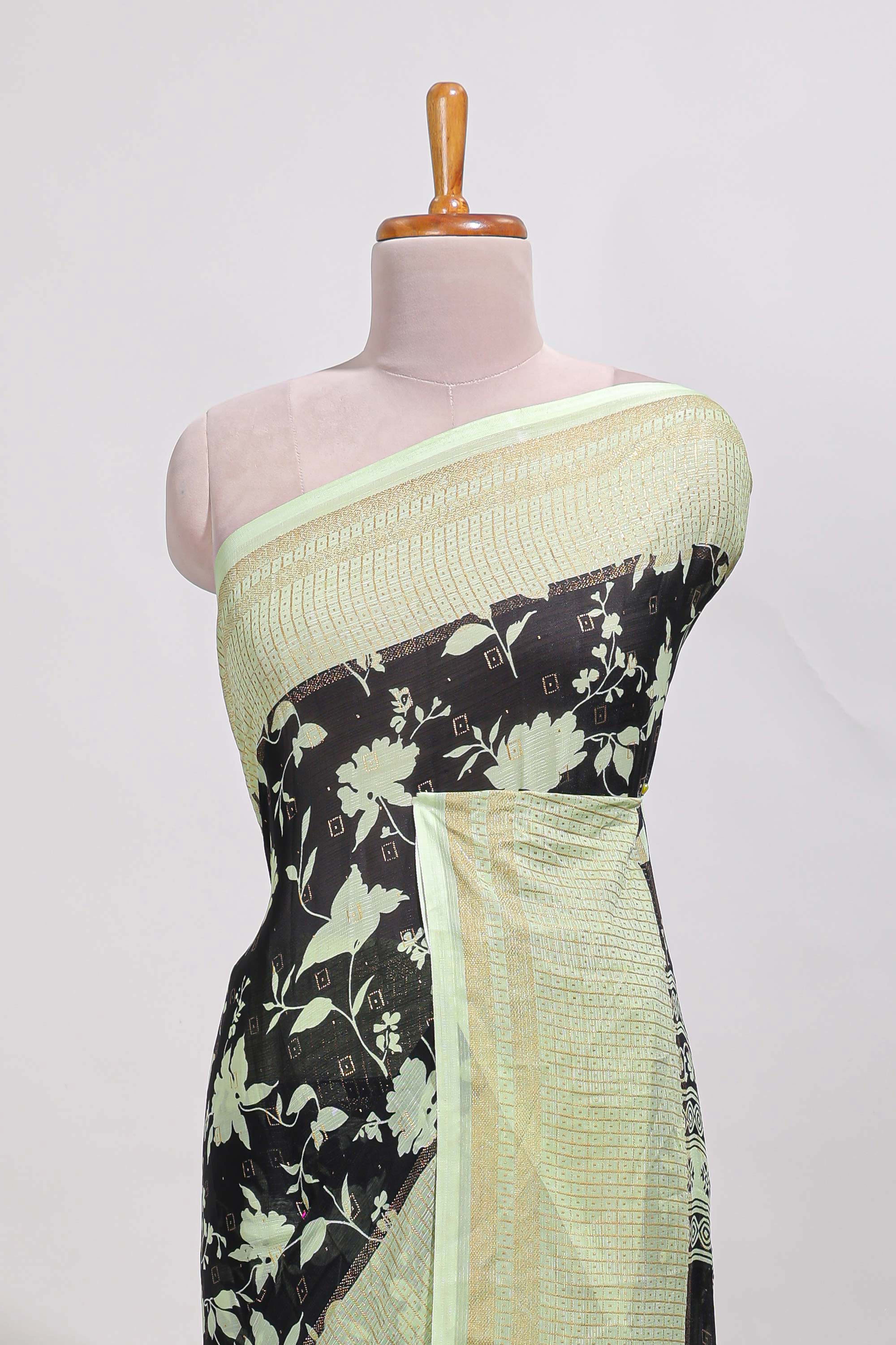 Black and green checked floral motifs chiffon saree with self zari border and contrast blouse