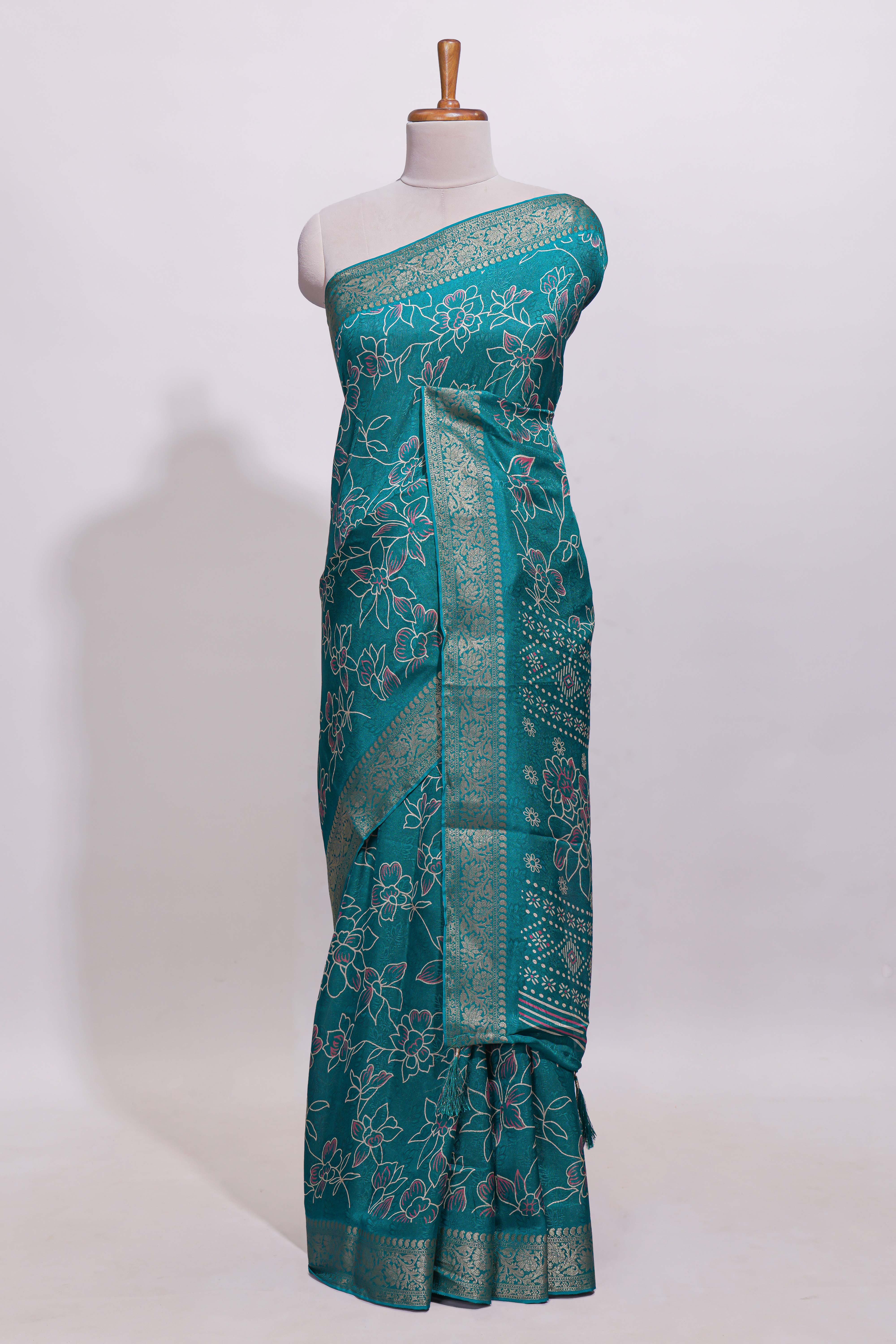 Teal green floral designed chiffon saree with self zari border and matching blouse
