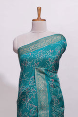 Teal green floral designed chiffon saree with self zari border and matching blouse