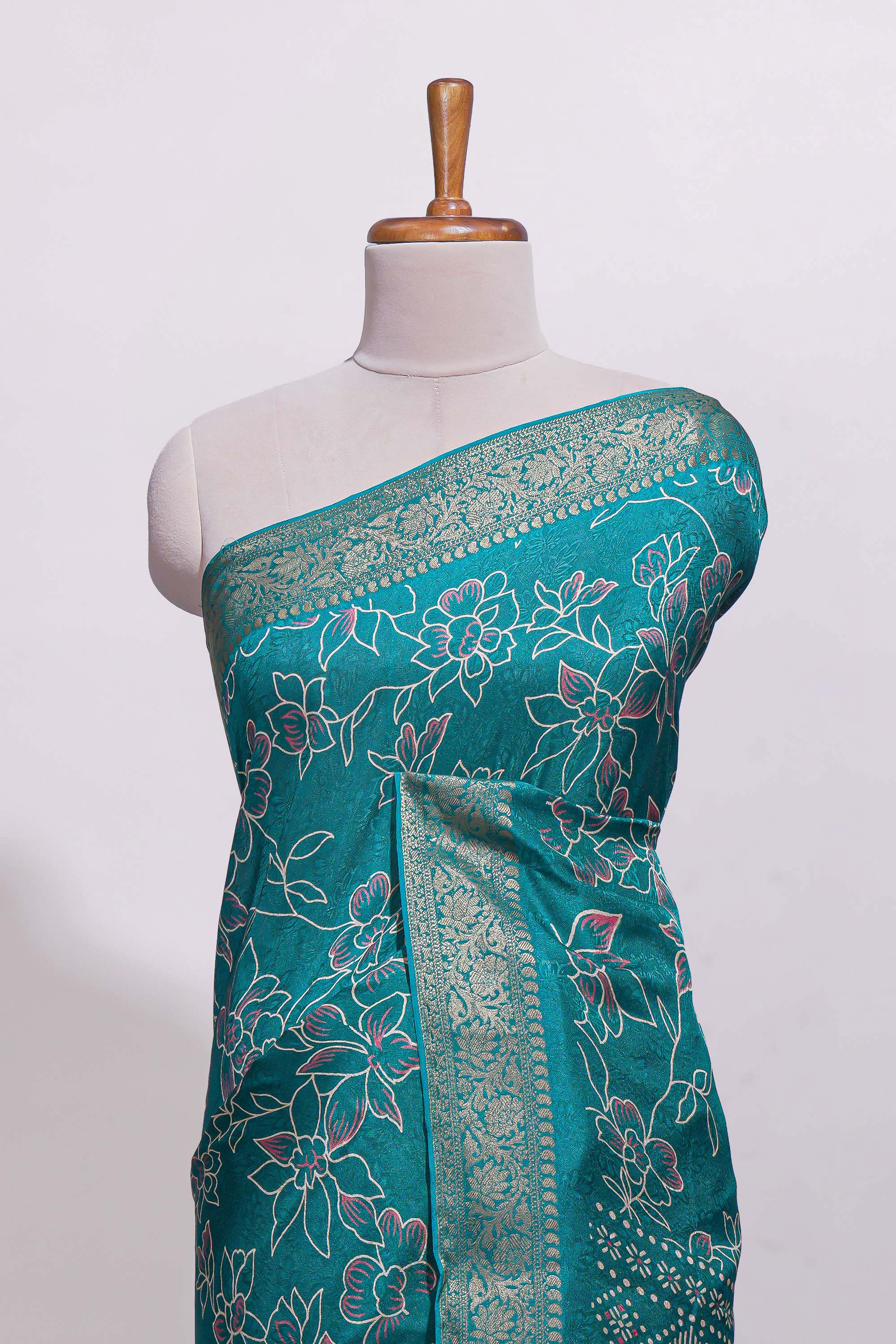 Teal green floral designed chiffon saree with self zari border and matching blouse