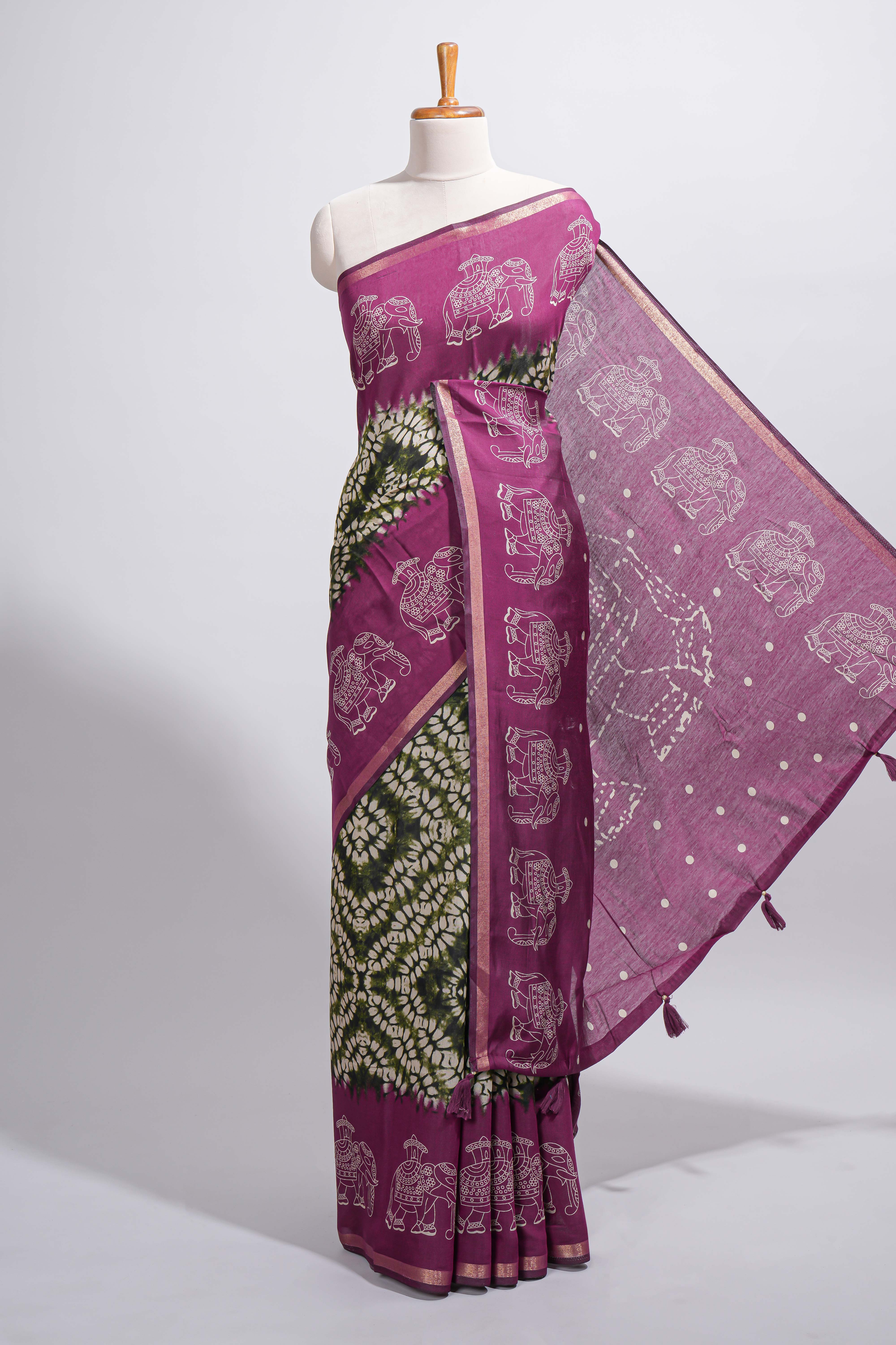 Dark green Chanderi cotton saree with elephant motifs tie and dye effect patterns and contrast zari border along with printed blouse