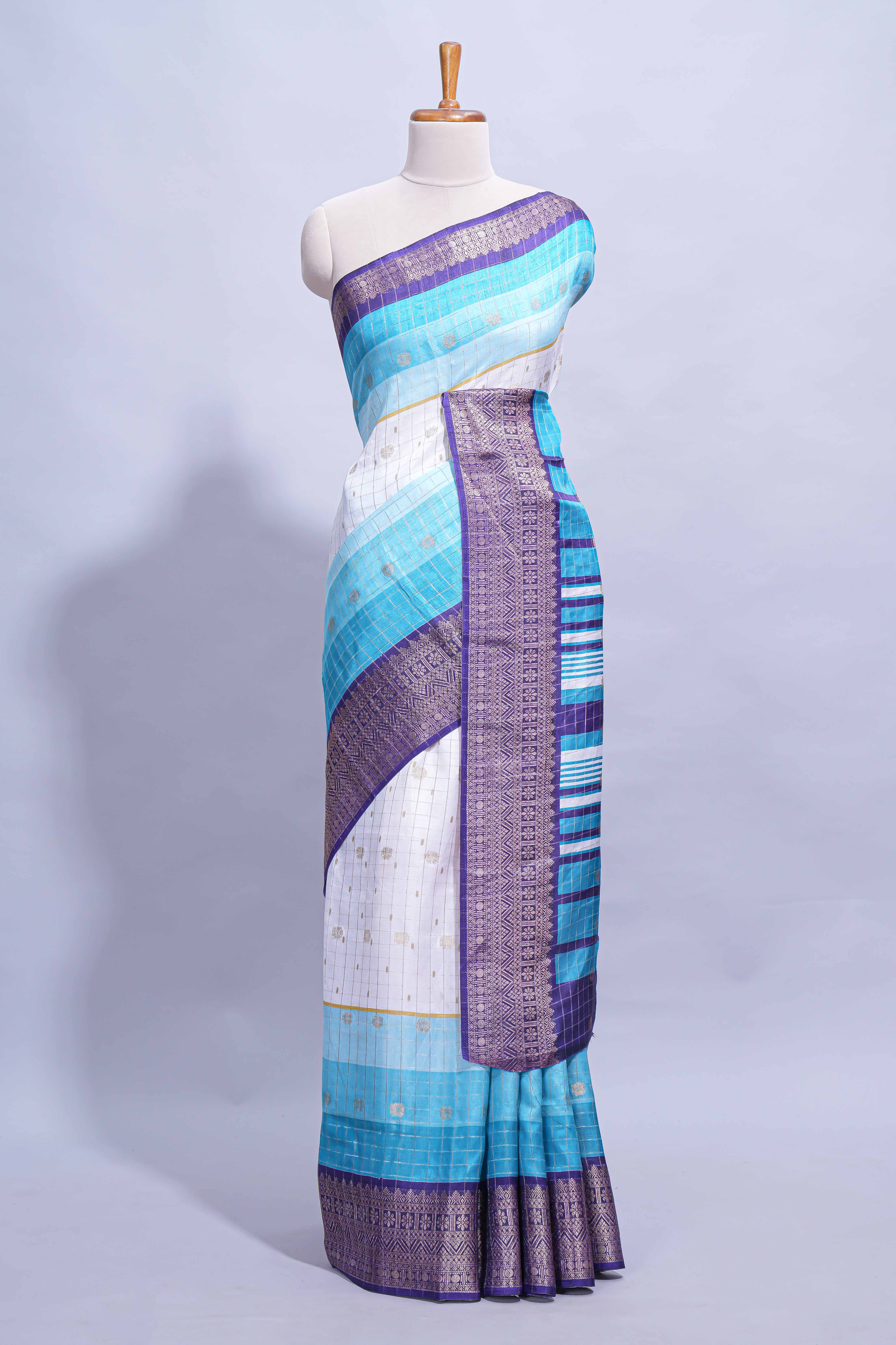 White and Aqua Blue Dola Silk Saree with rich zari border woven butis and a designer pallu along with contrast blouse