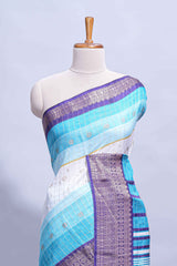White and Aqua Blue Dola Silk Saree with rich zari border woven butis and a designer pallu along with contrast blouse