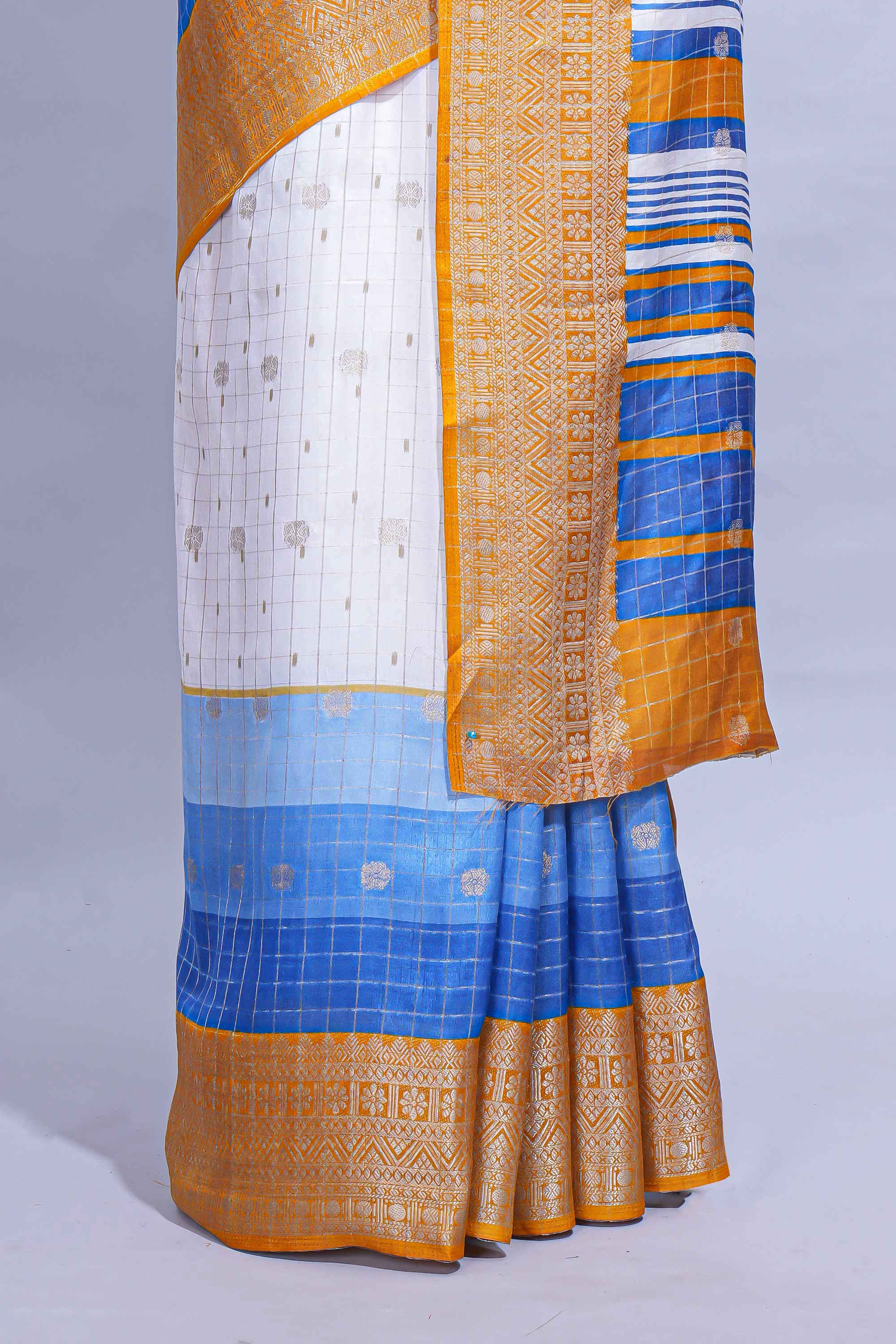 White and blue Dola Silk Saree with rich zari border woven butis and a designer pallu along with contrast blouse