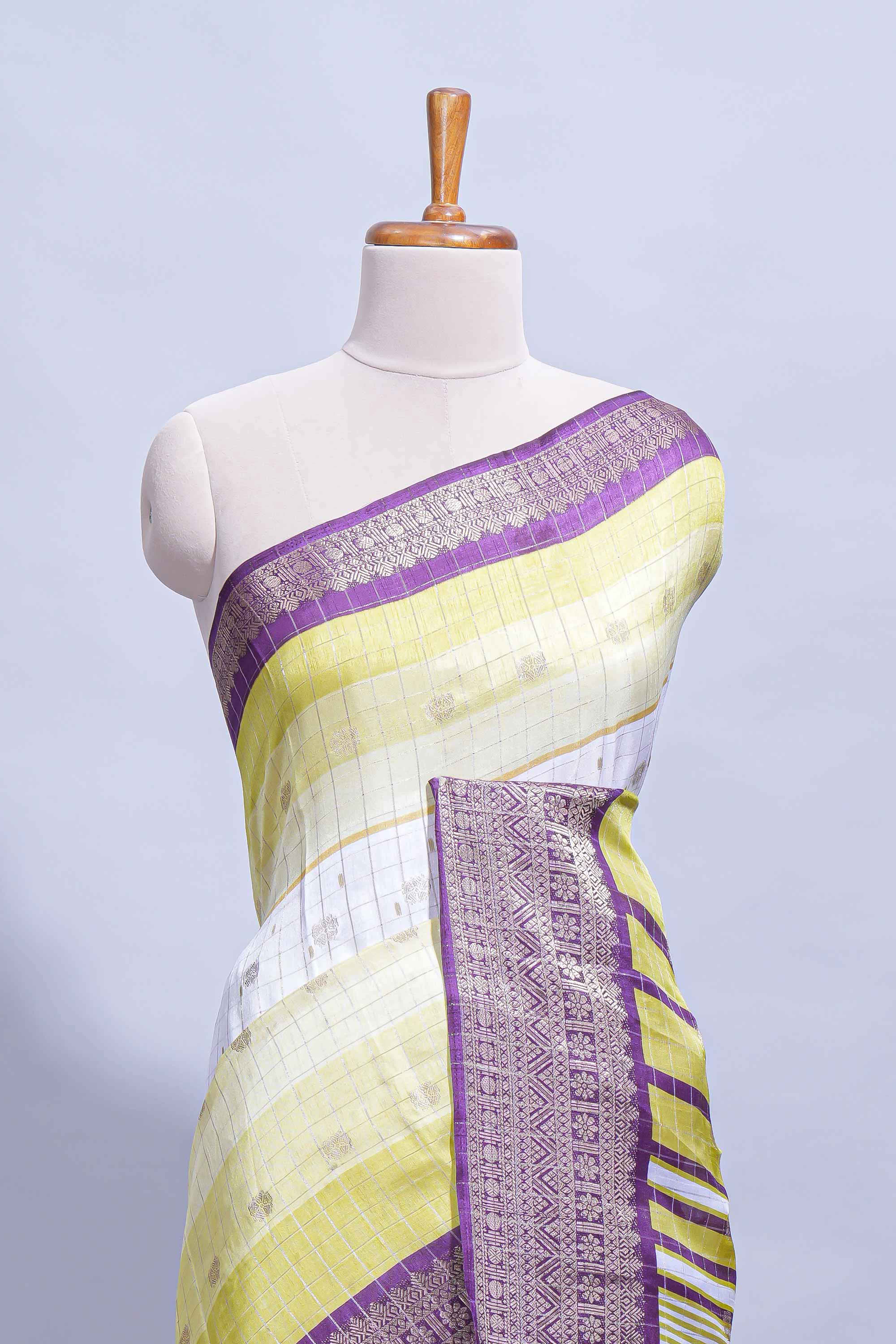 White and yellow Dola Silk Saree with rich zari border woven butis and a designer pallu along with contrast blouse