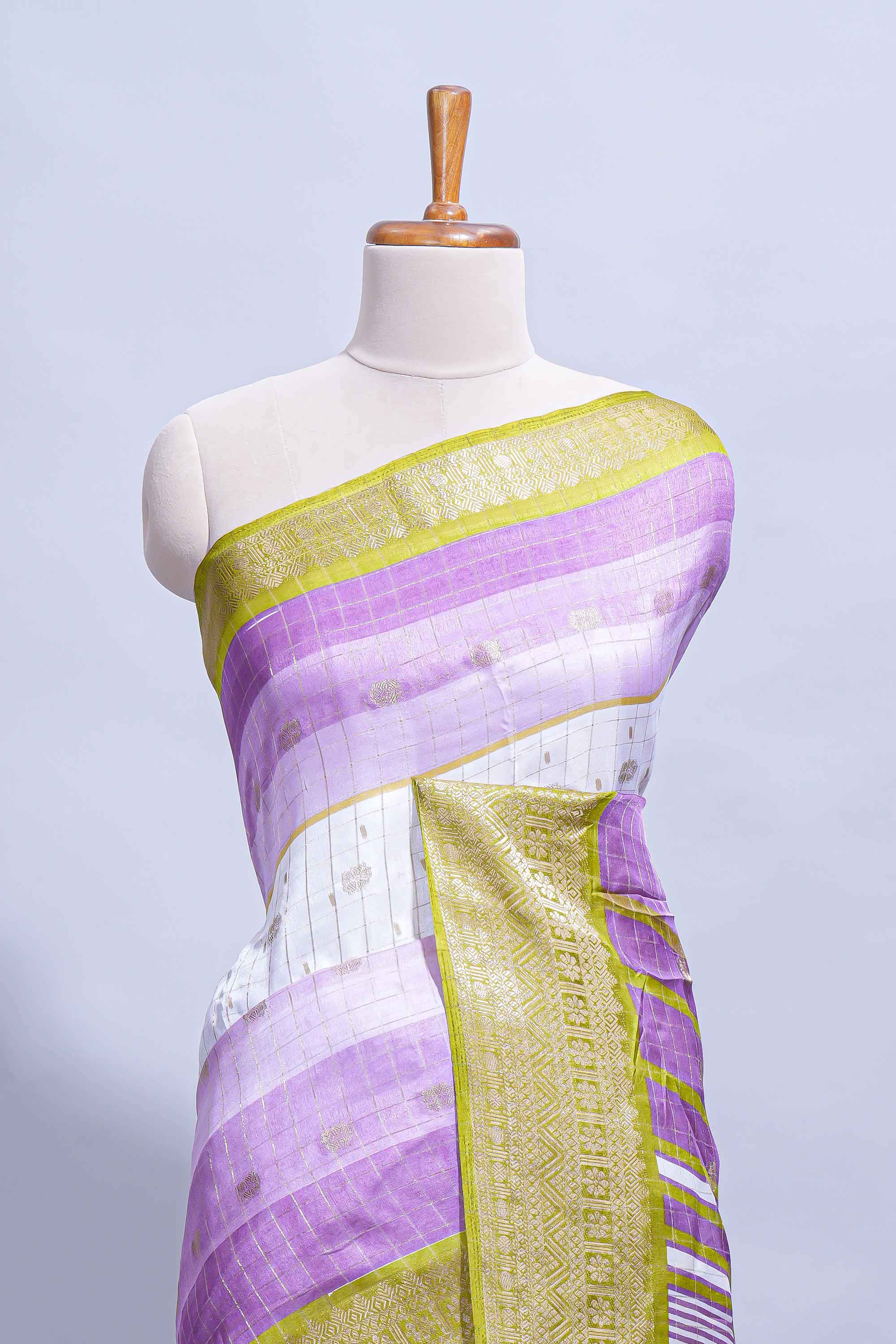 White and purple Dola Silk Saree with rich zari border woven butis and a designer pallu along with contrast blouse