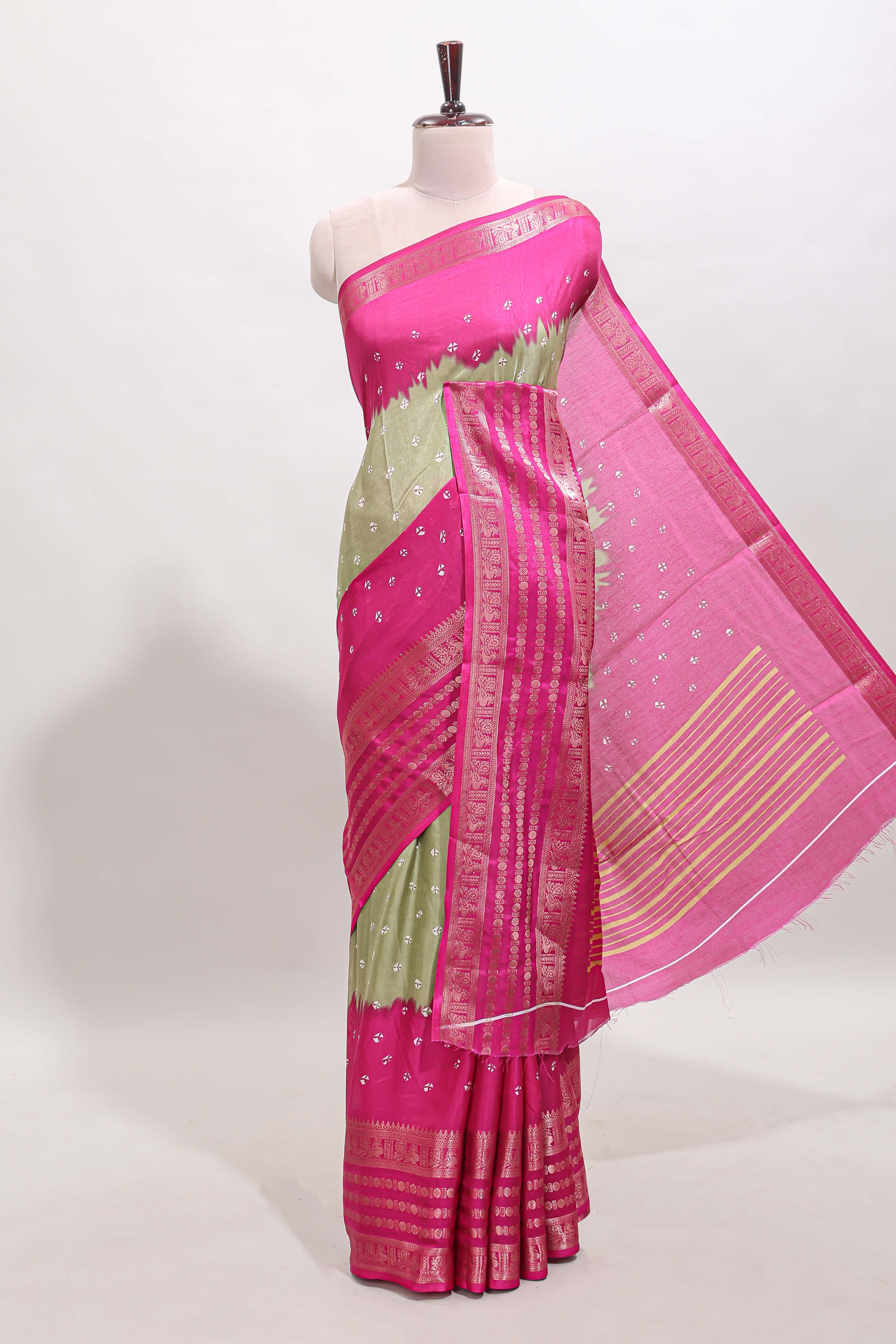 Green unique buttas dola silk saree with contrast zari border and blouse