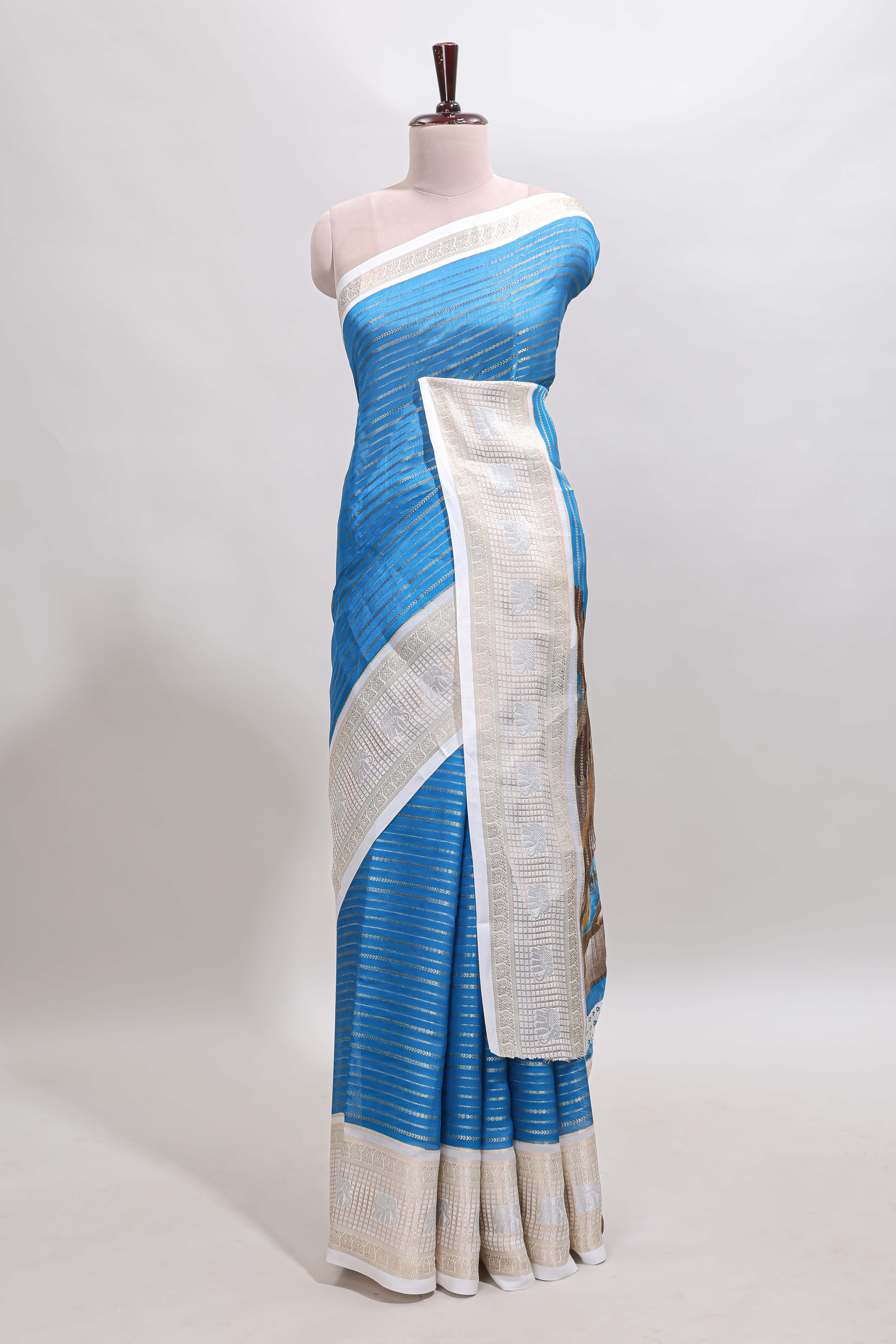 Blue zari striped dola silk saree withcontrast zari border and printed blouse