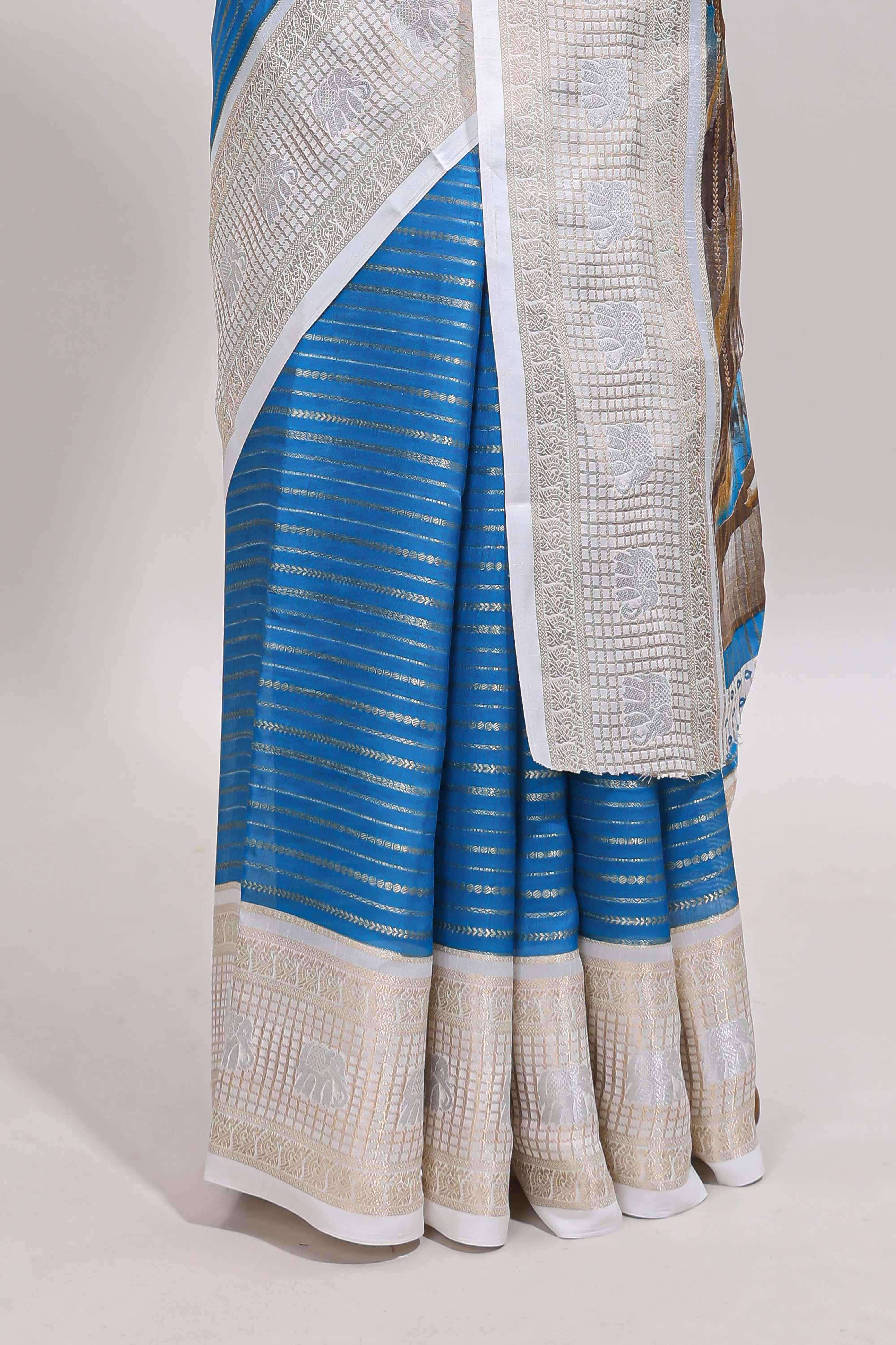 Blue zari striped dola silk saree withcontrast zari border and printed blouse