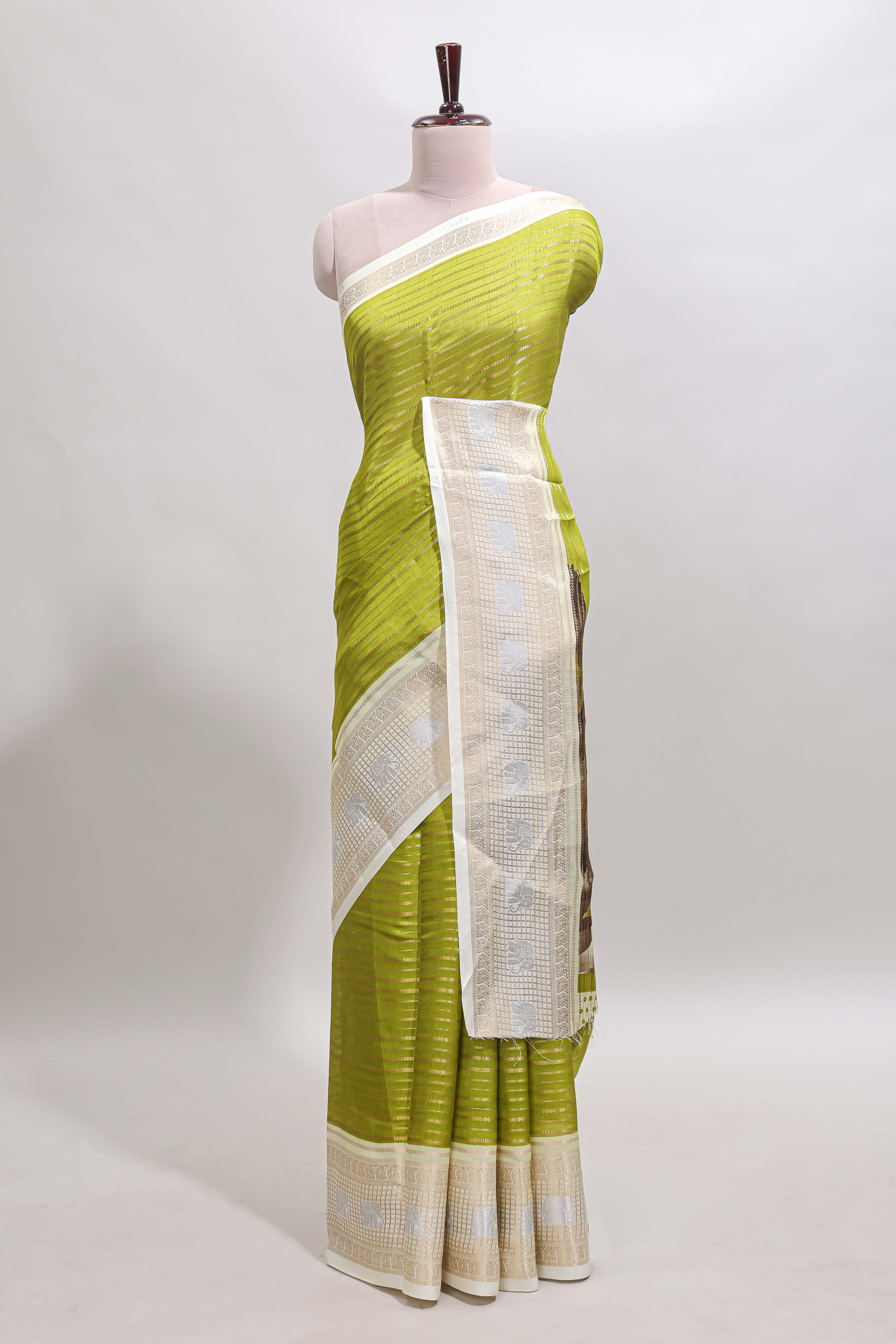 Green zari striped dola silk saree withcontrast zari border and printed blouse