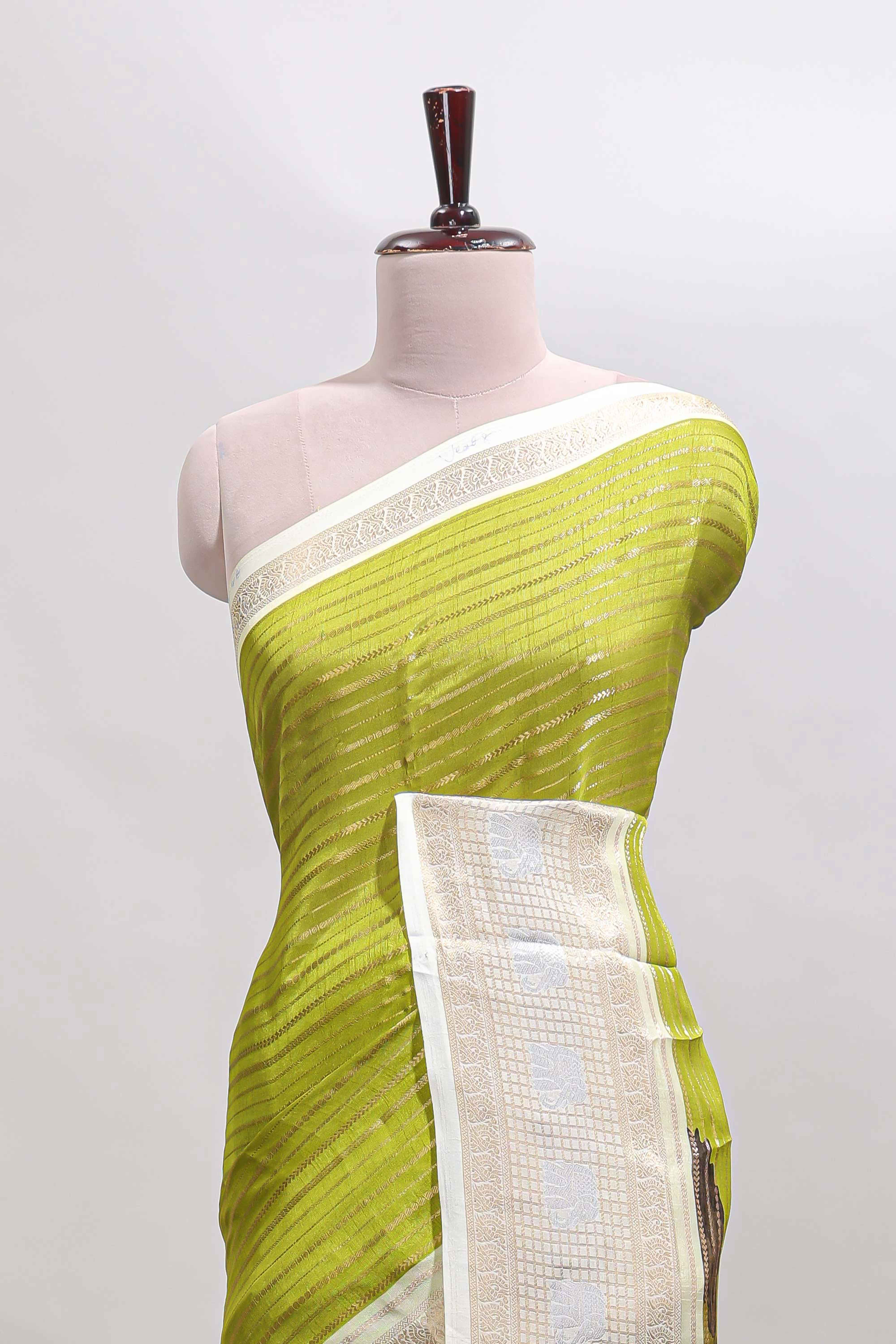 Green zari striped dola silk saree withcontrast zari border and printed blouse