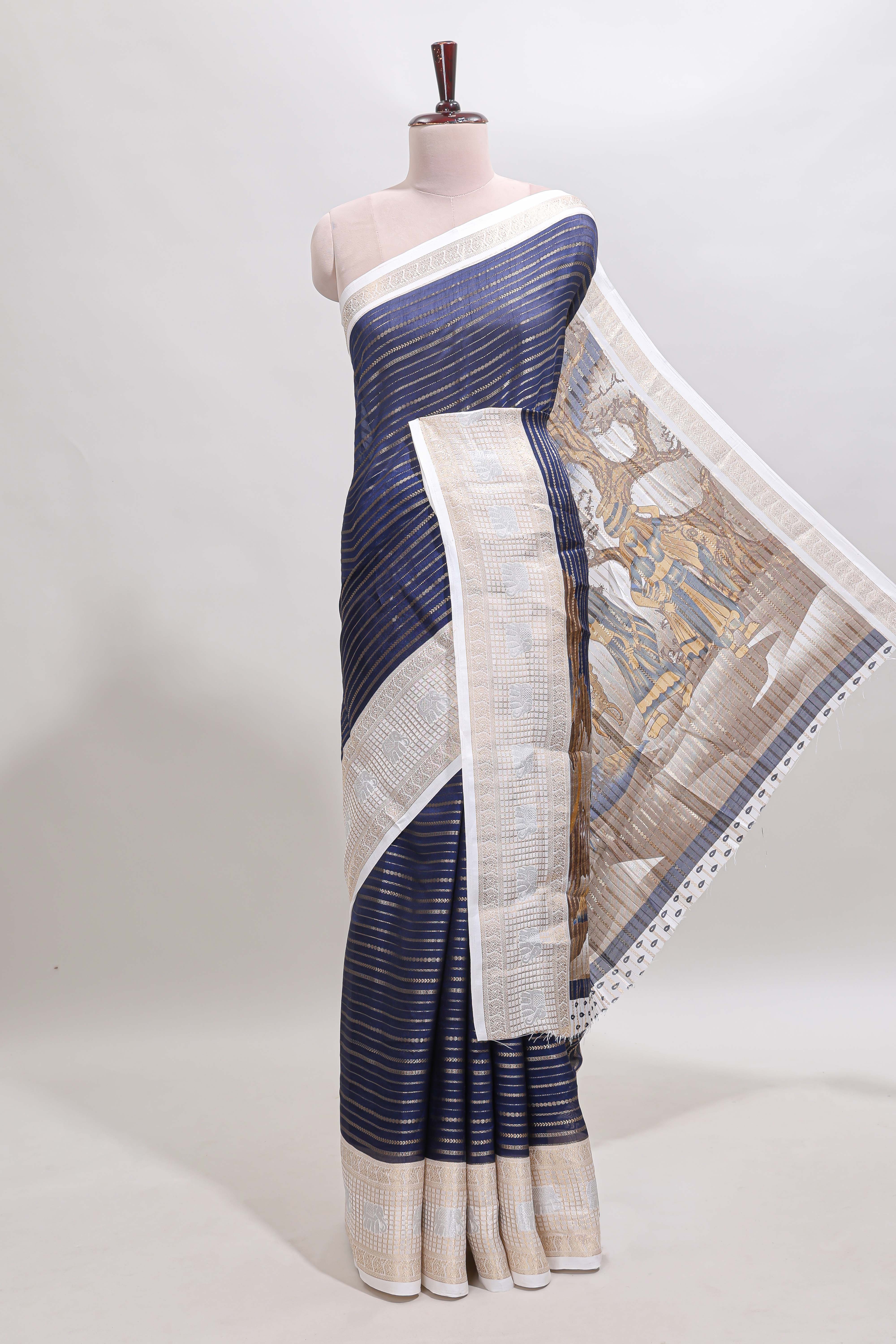 Dark blue zari striped dola silk saree withcontrast zari border and printed blouse