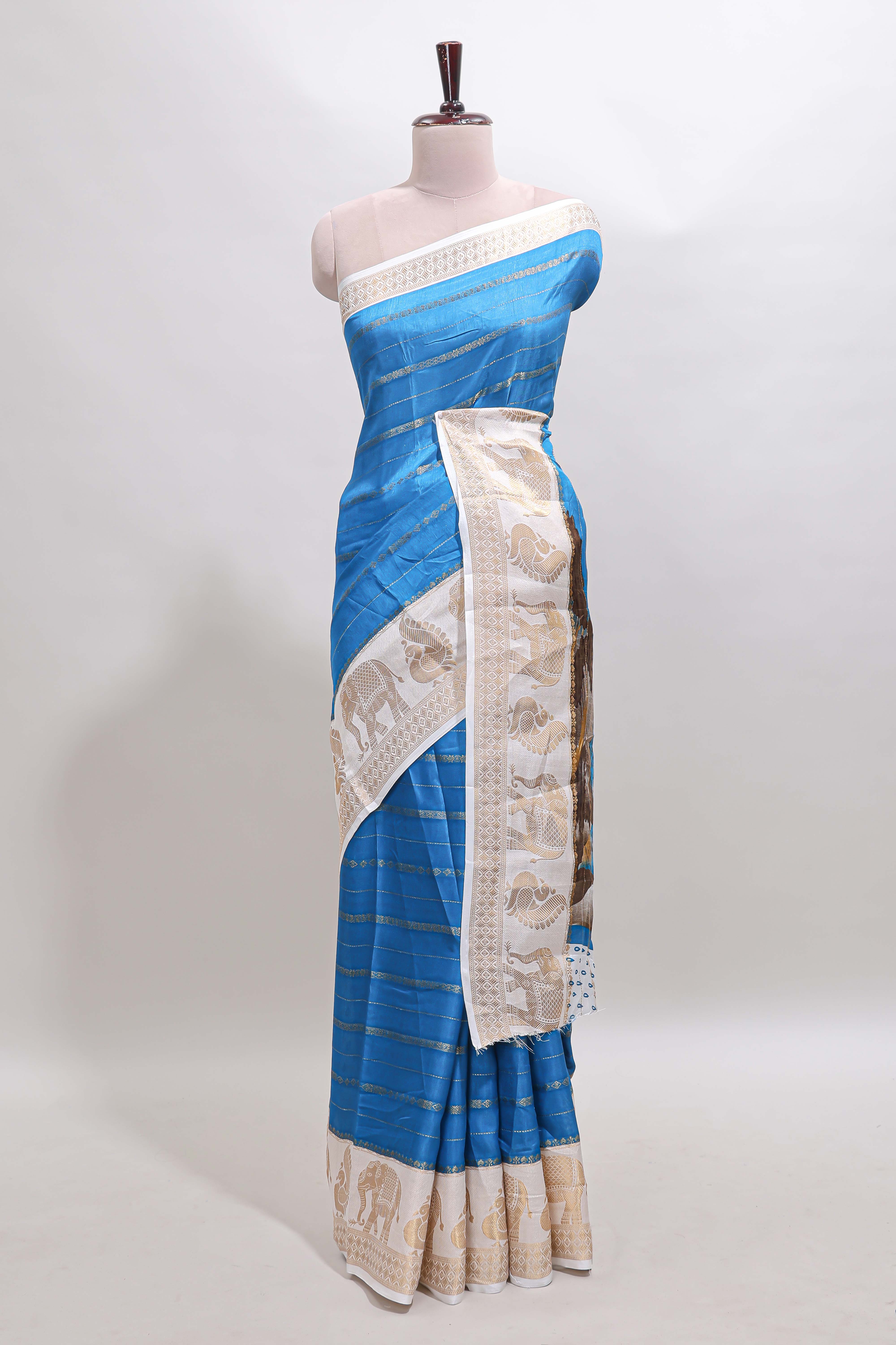 Peacock blue striped dola silk saree with contrast zari border and kalamkari style pallu