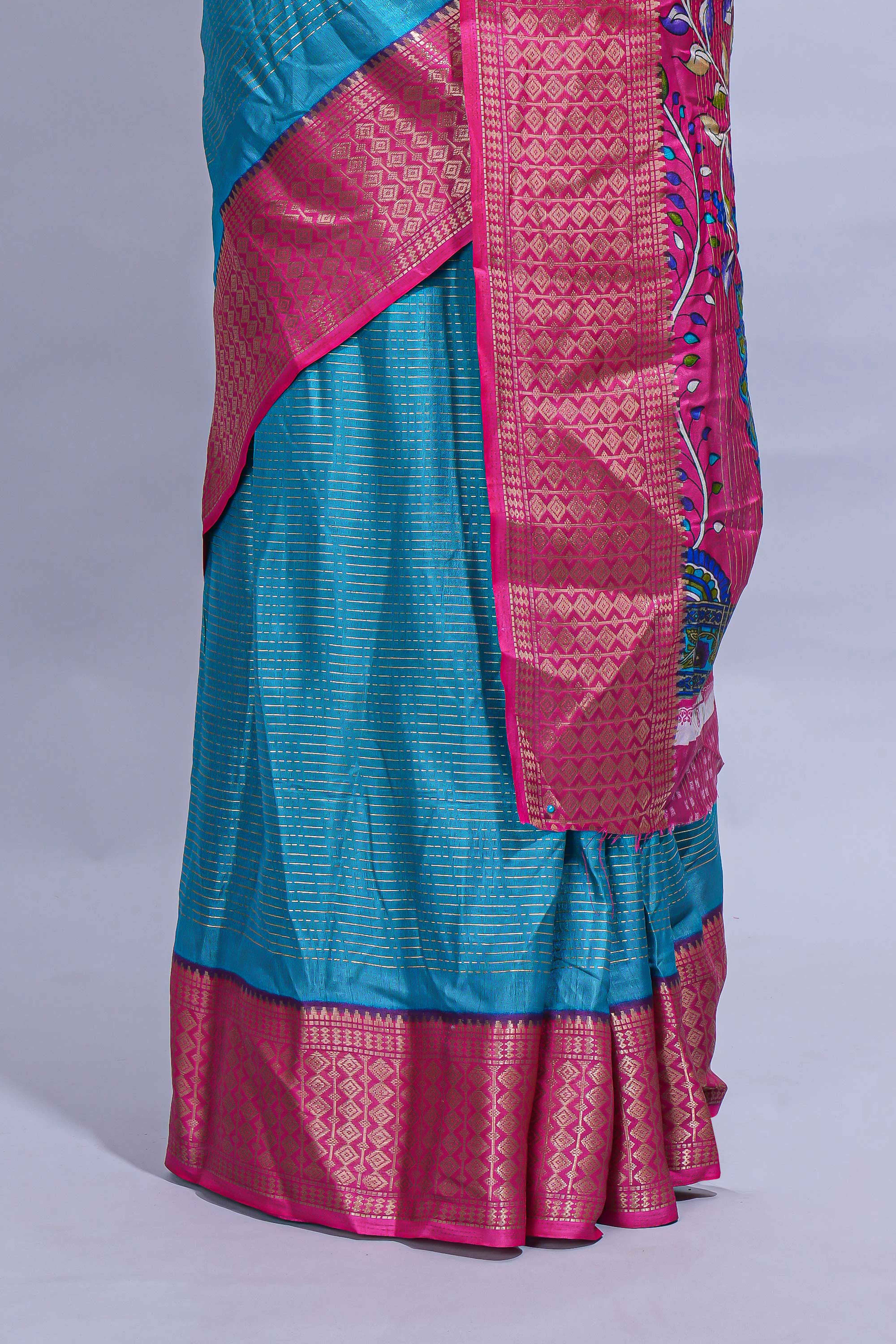 Turquoise blue dola silk saree with fine zari stripes contrastzari border and a rich peacock floral woven pallu along with printed contrast blouse