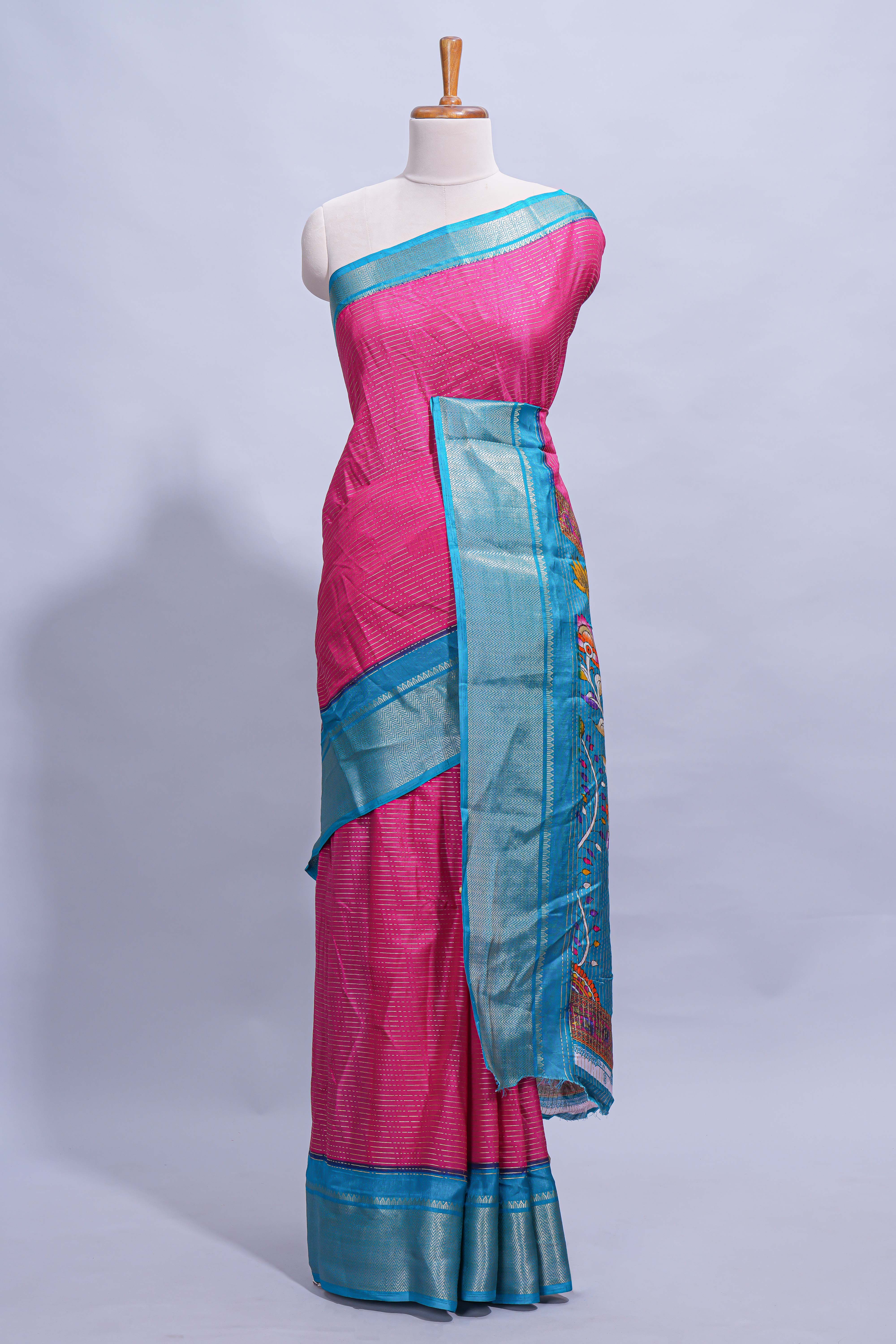 Pink dola silk saree with fine zari stripes contrastzari border and a rich peacock floral woven pallu along with printed contrast blouse