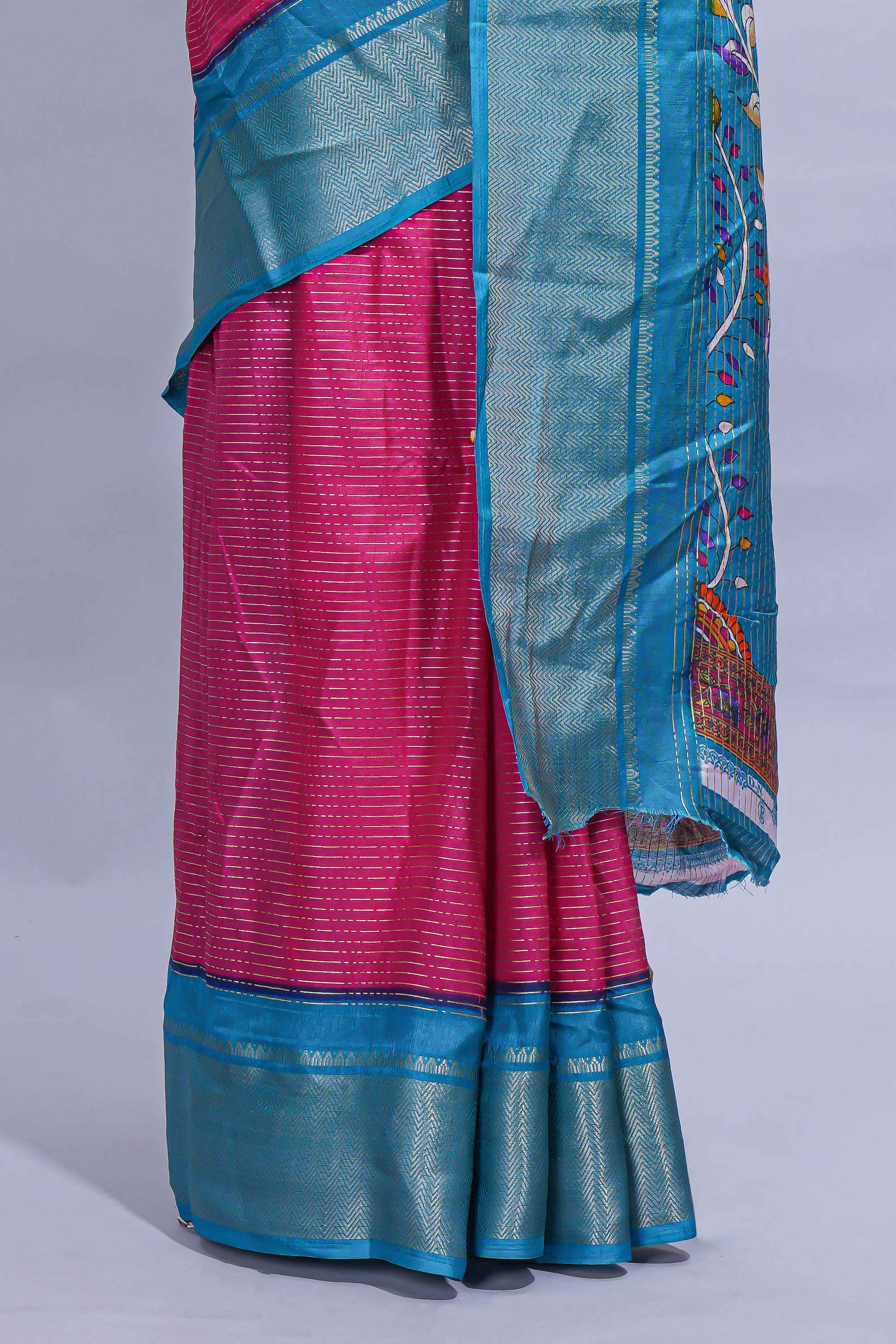 Pink dola silk saree with fine zari stripes contrastzari border and a rich peacock floral woven pallu along with printed contrast blouse