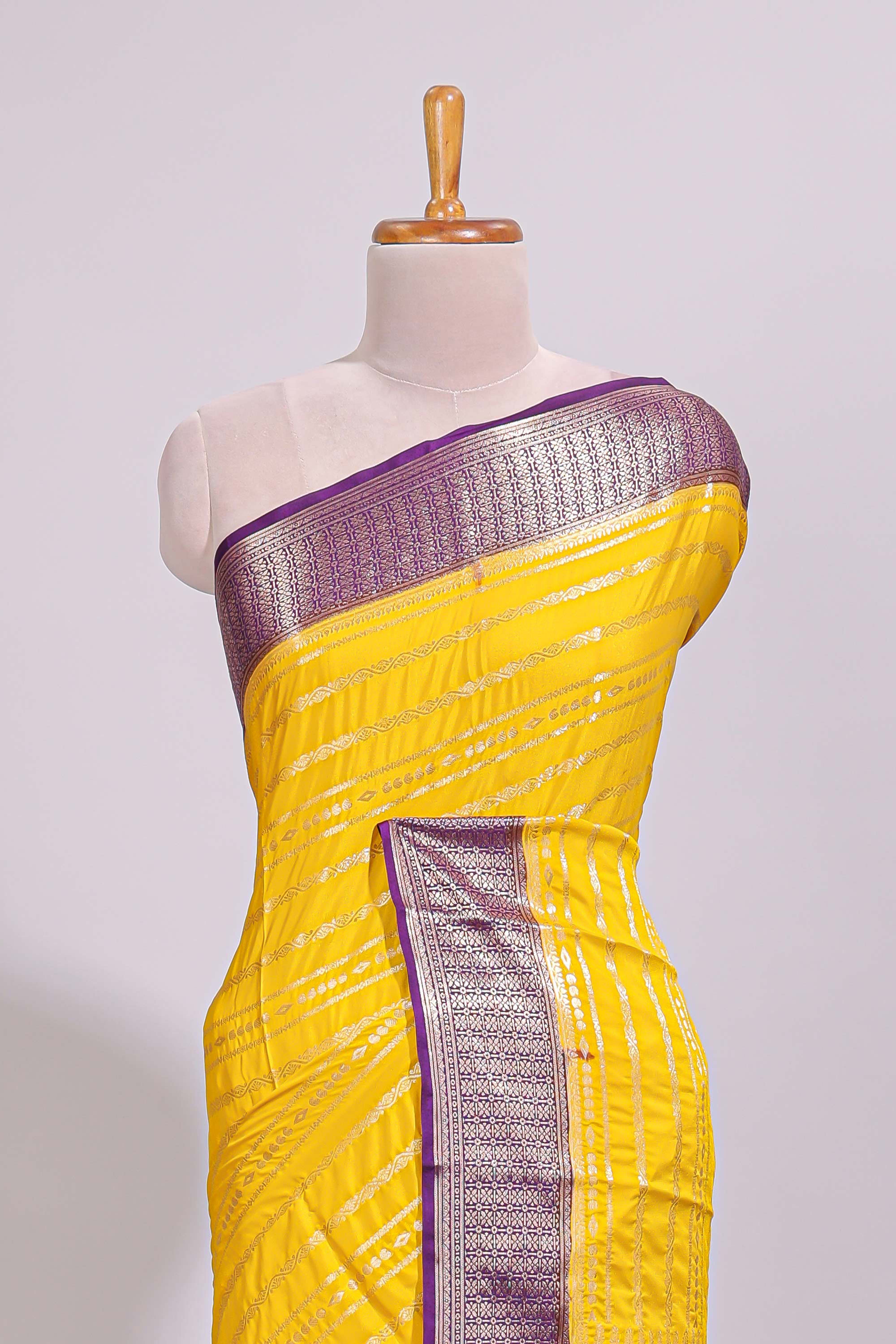 Yellow zari striped dola silk saree with contrast zari border and striped pallu