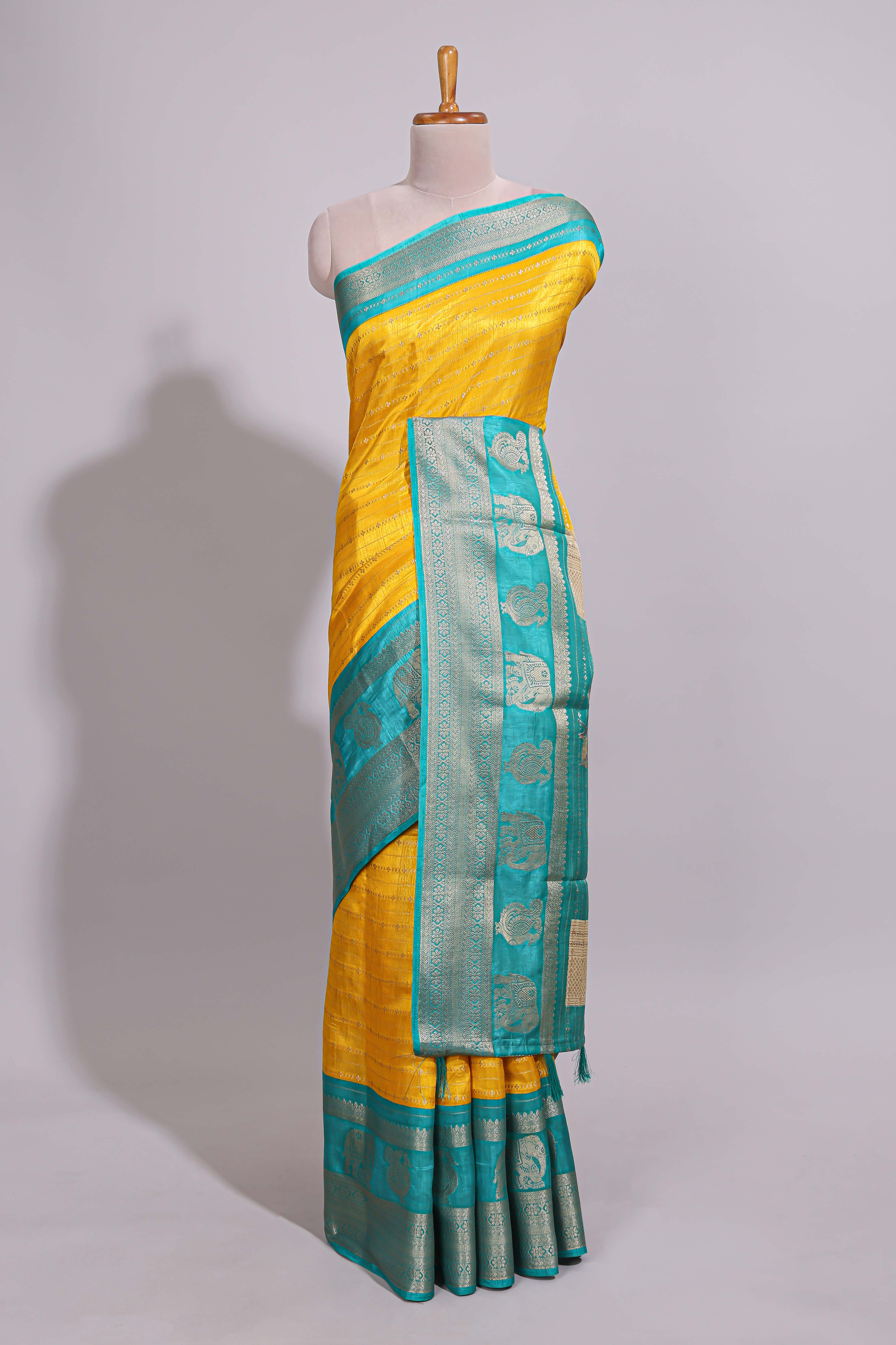 Yellow zari striped dola silk saree with contrast zari border and floral printed pallu