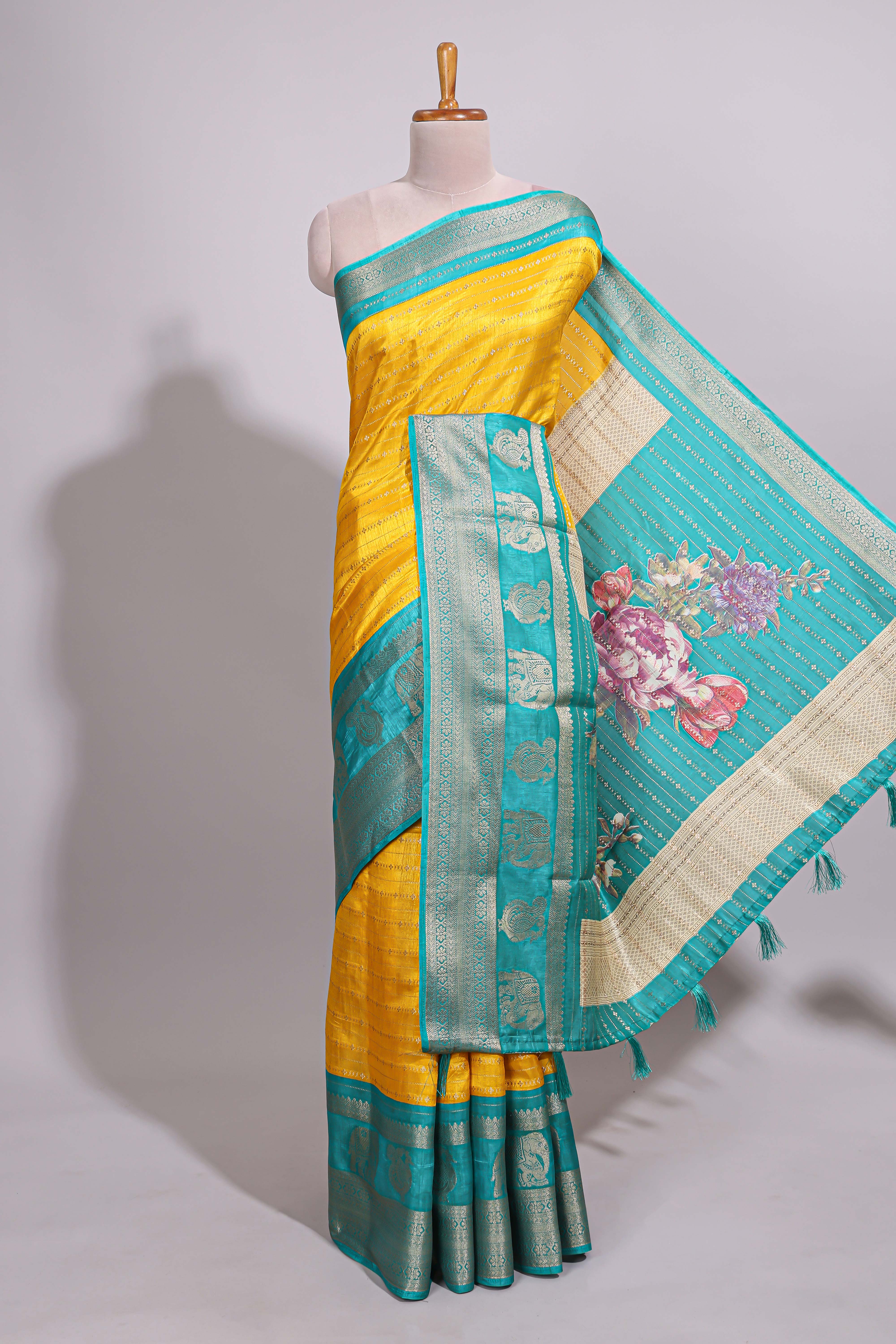 Yellow zari striped dola silk saree with contrast zari border and floral printed pallu