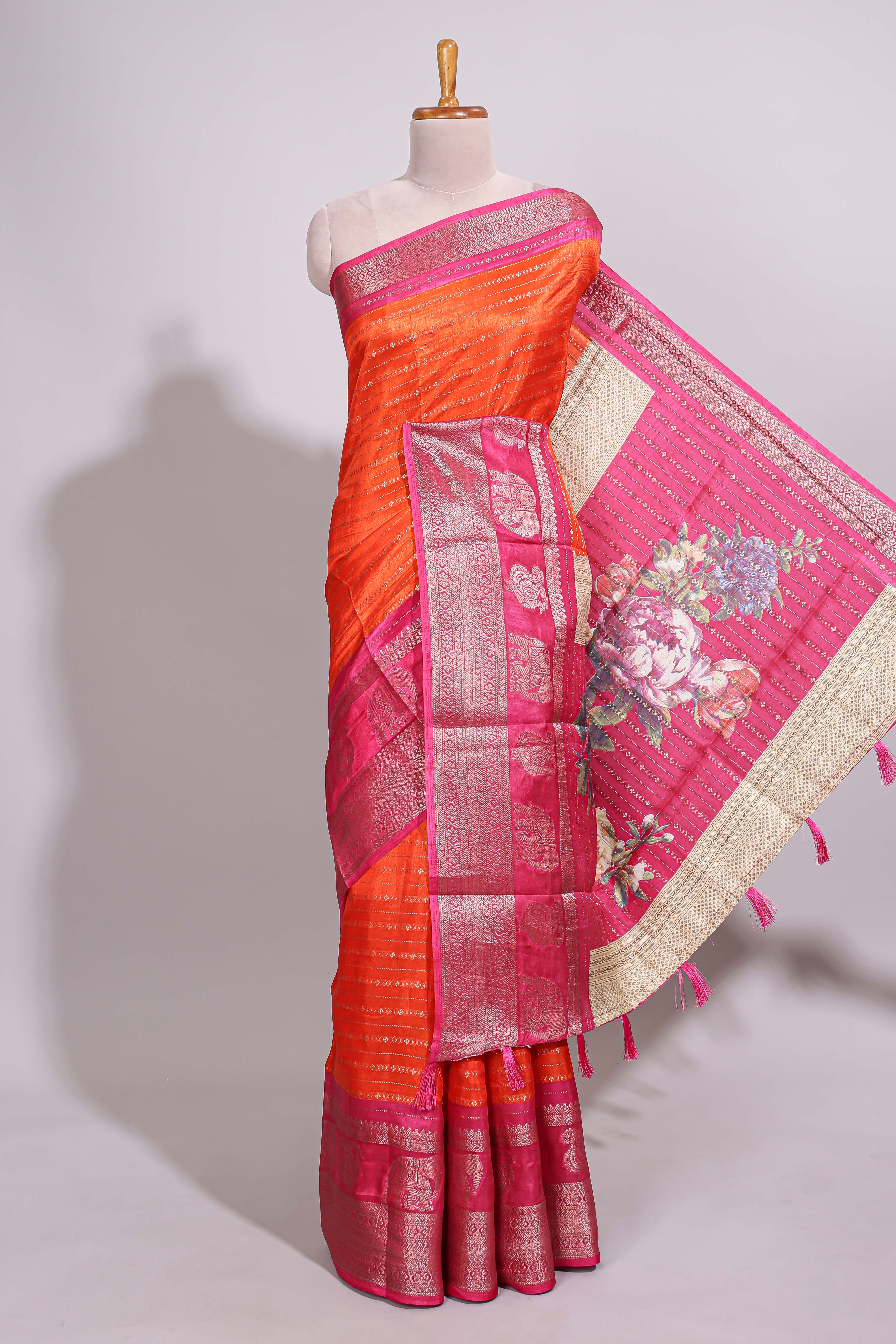 Orange zari striped dola silk saree with contrast zari border and floral printed pallu