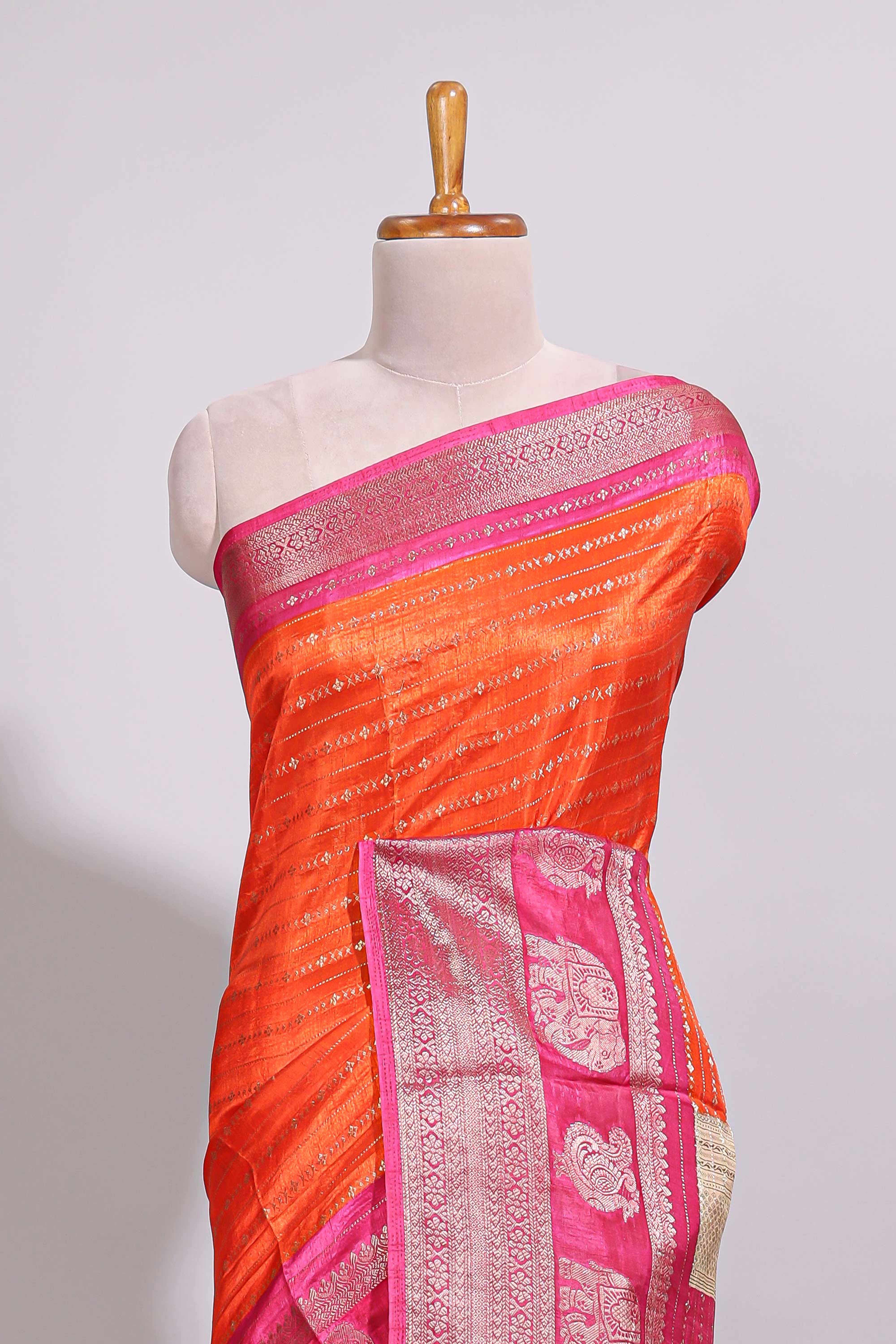 Orange zari striped dola silk saree with contrast zari border and floral printed pallu