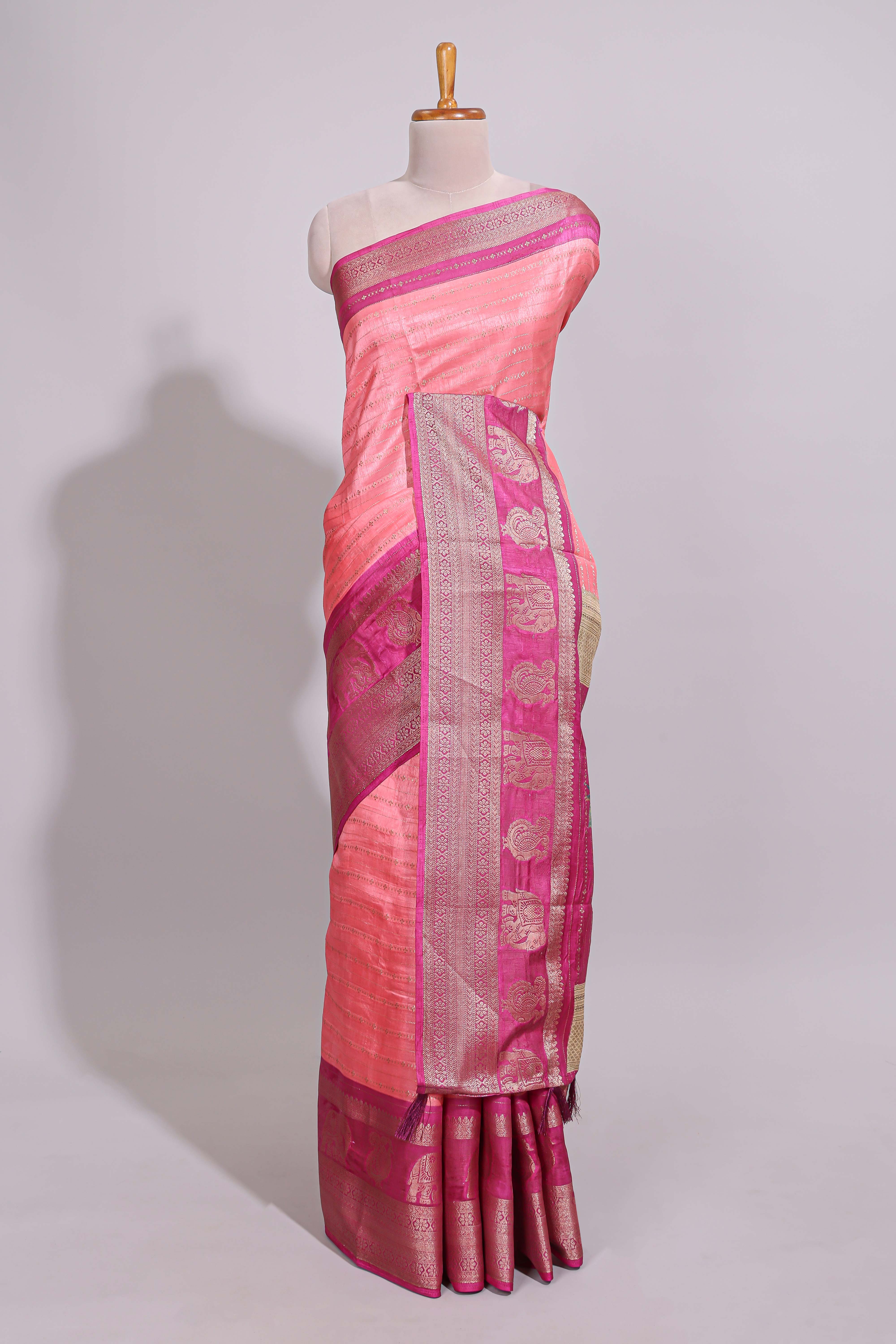 Peach zari striped dola silk saree with contrast zari border and floral printed pallu