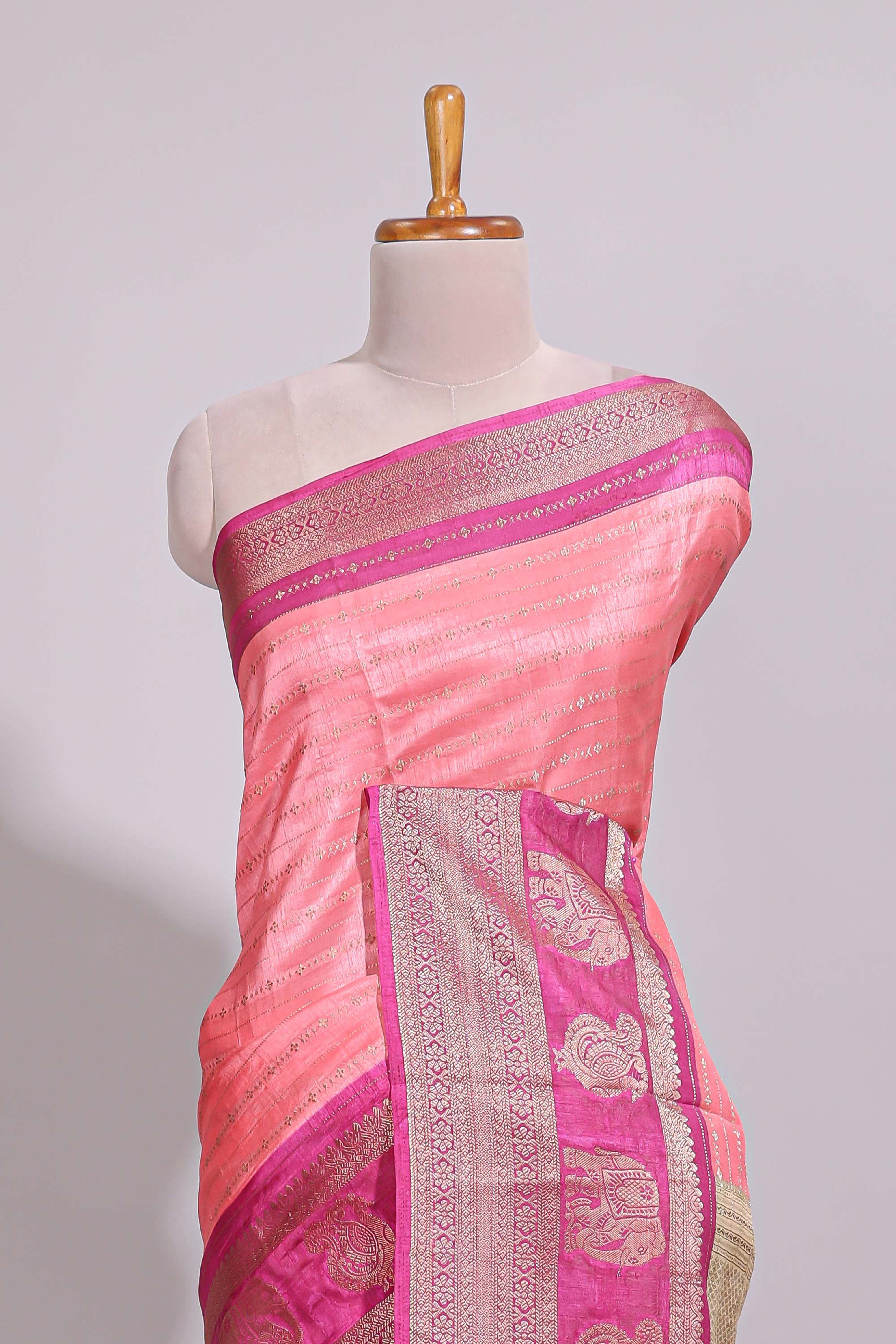 Peach zari striped dola silk saree with contrast zari border and floral printed pallu