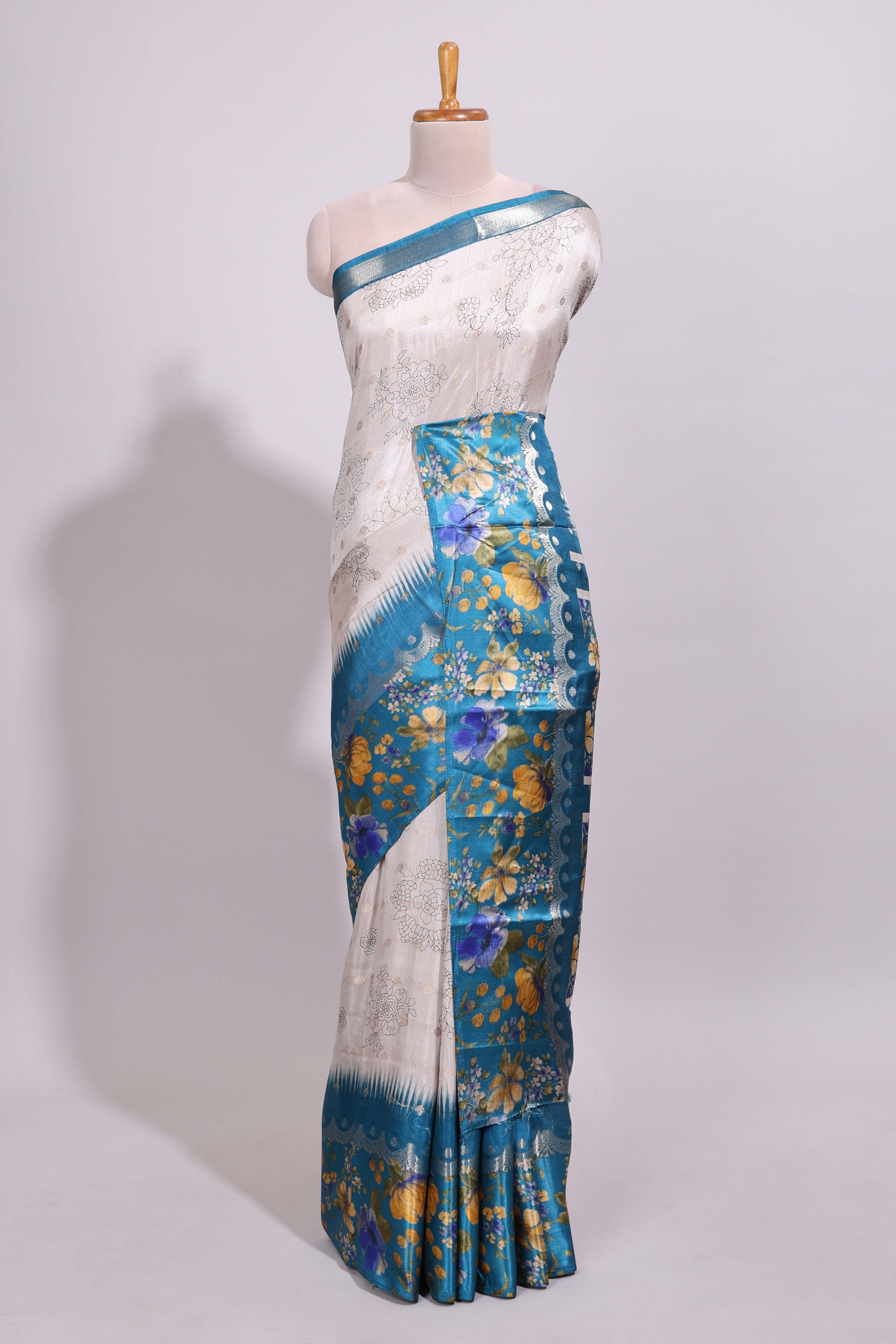 Off white floral design dola silk saree with contrast turquoise green floral border and printed motifs blouse
