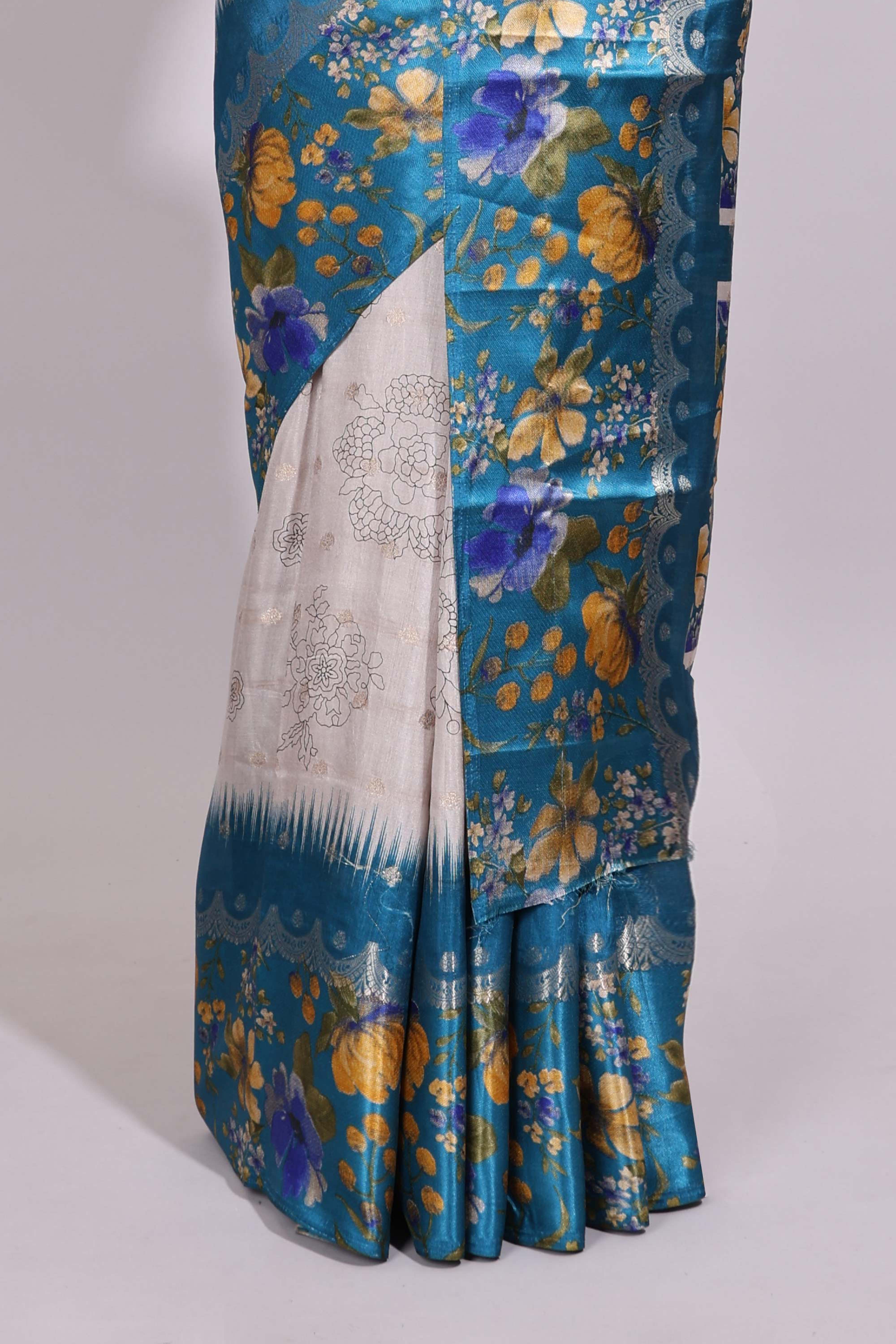 Off white floral design dola silk saree with contrast turquoise green floral border and printed motifs blouse