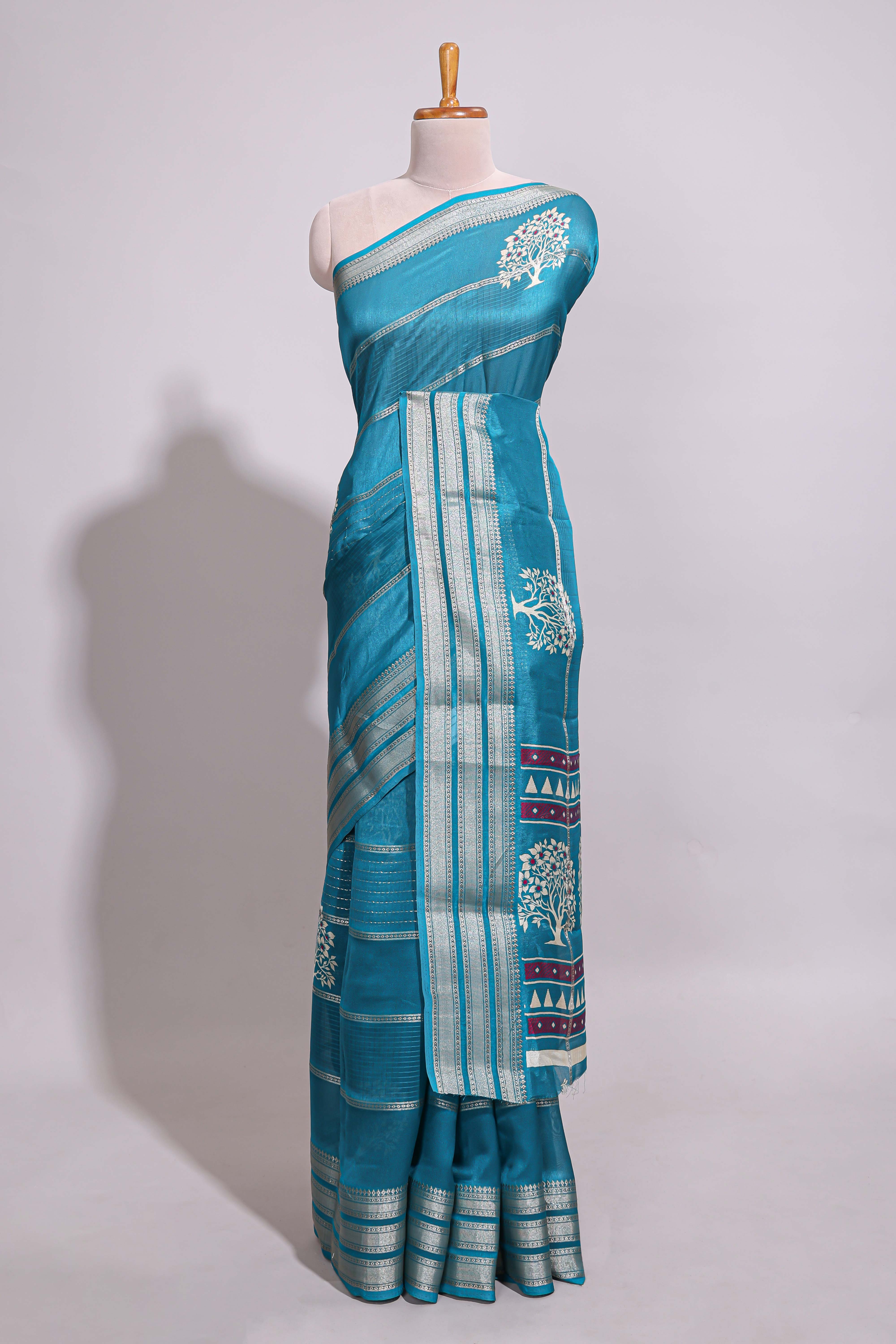 Teal blue Dola silk saree all over zari lines and motifs design with silver zariborder and self printed pallu and matching blouse