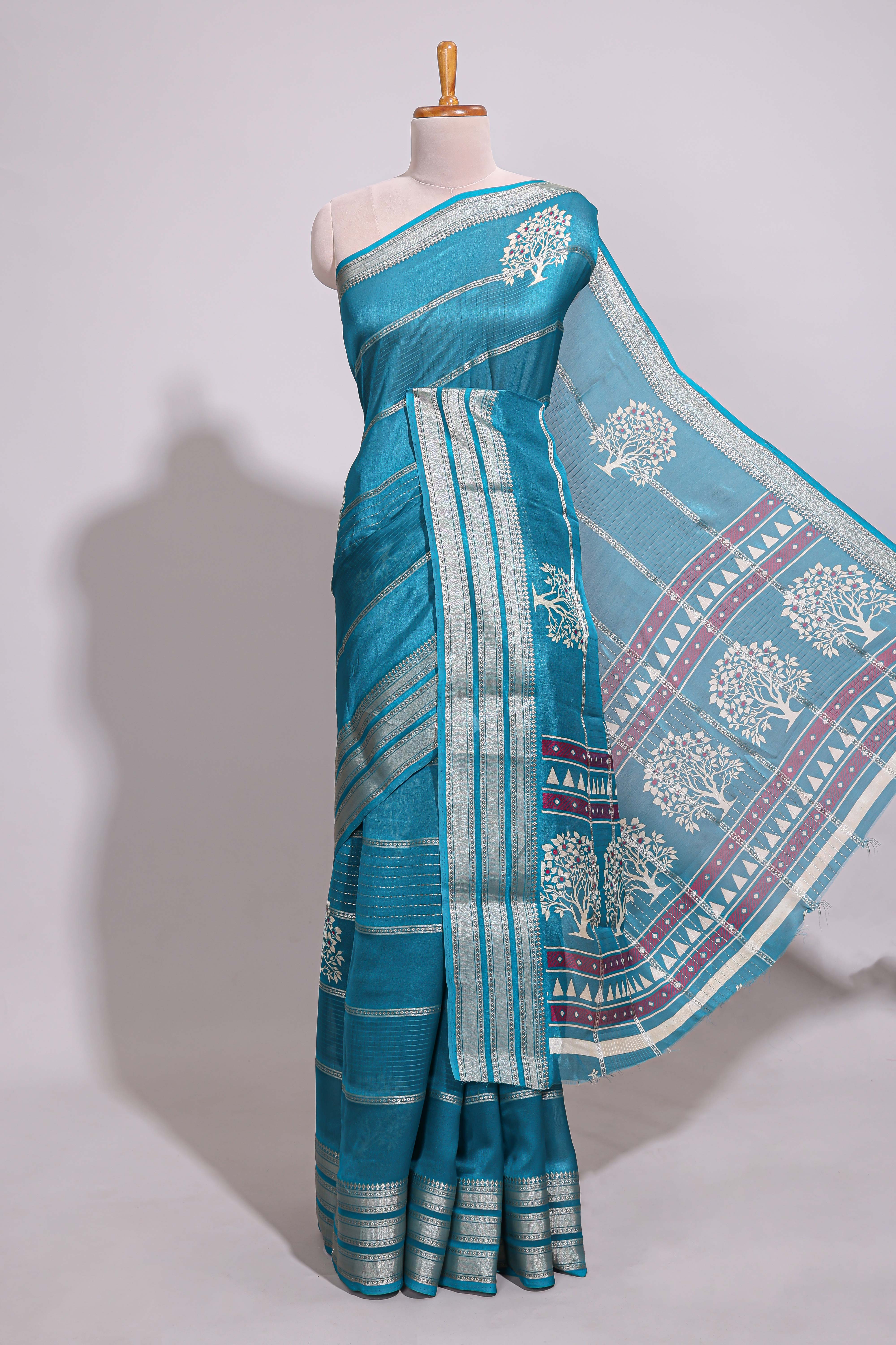 Teal blue Dola silk saree all over zari lines and motifs design with silver zariborder and self printed pallu and matching blouse