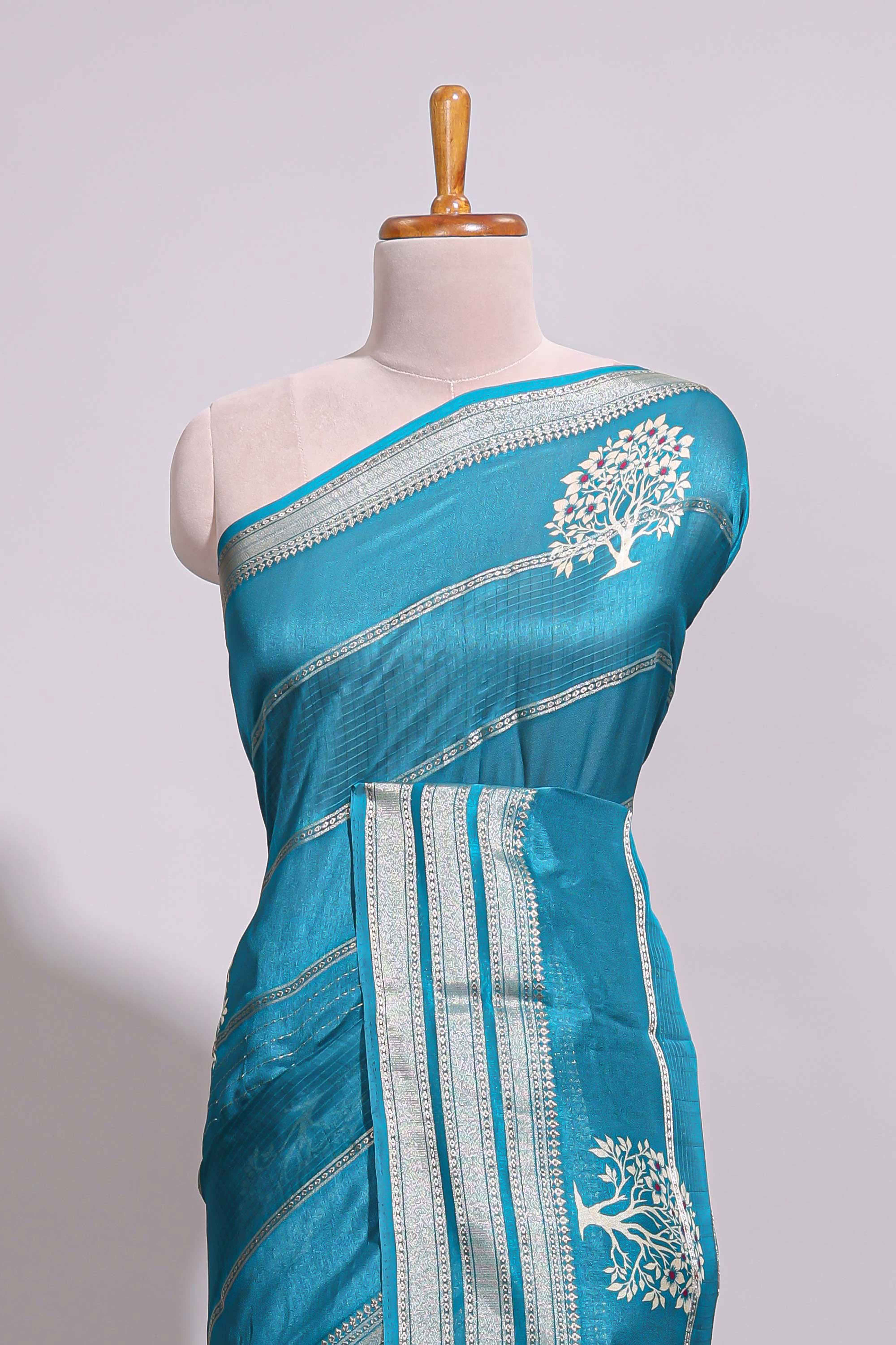 Teal blue Dola silk saree all over zari lines and motifs design with silver zariborder and self printed pallu and matching blouse