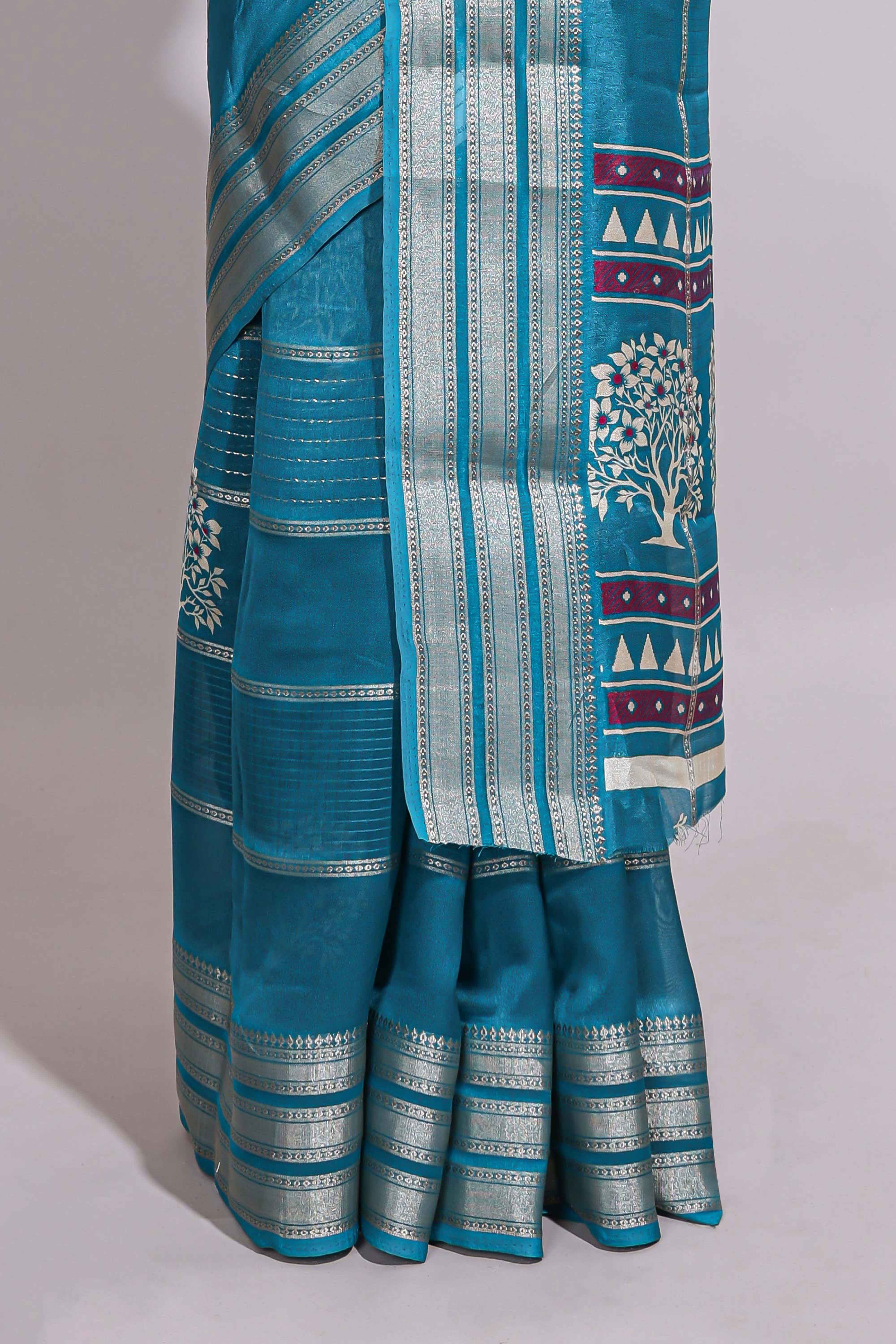 Teal blue Dola silk saree all over zari lines and motifs design with silver zariborder and self printed pallu and matching blouse