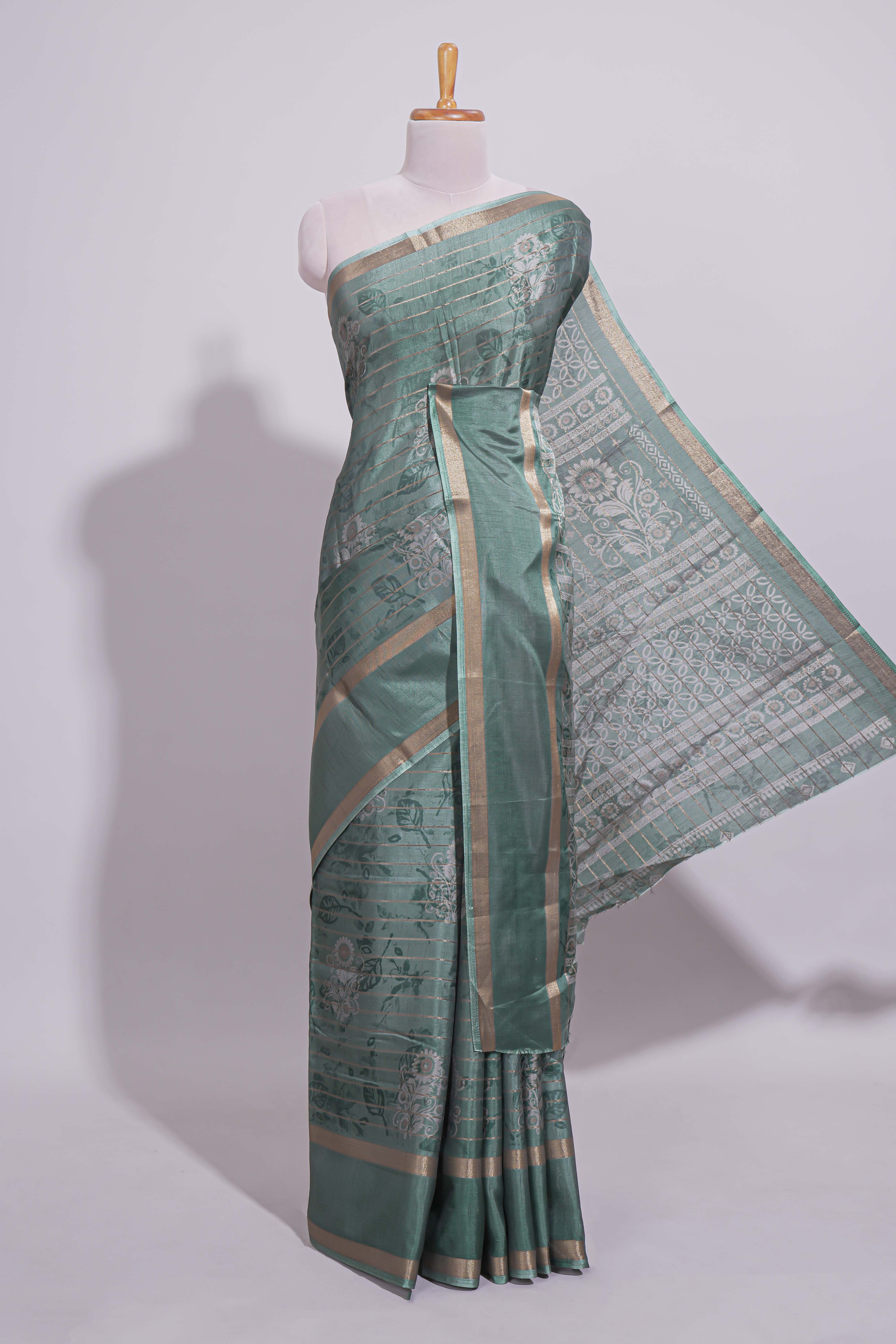 Teal green Dola Silk Saree all over floral motifs fine zari stripes and zari border with matching printed blouse