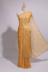 Mustard yellow saree with elegant sequin embellishments and a shimmering border along with matching blouse