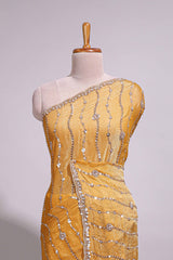 Mustard yellow saree with elegant sequin embellishments and a shimmering border along with matching blouse