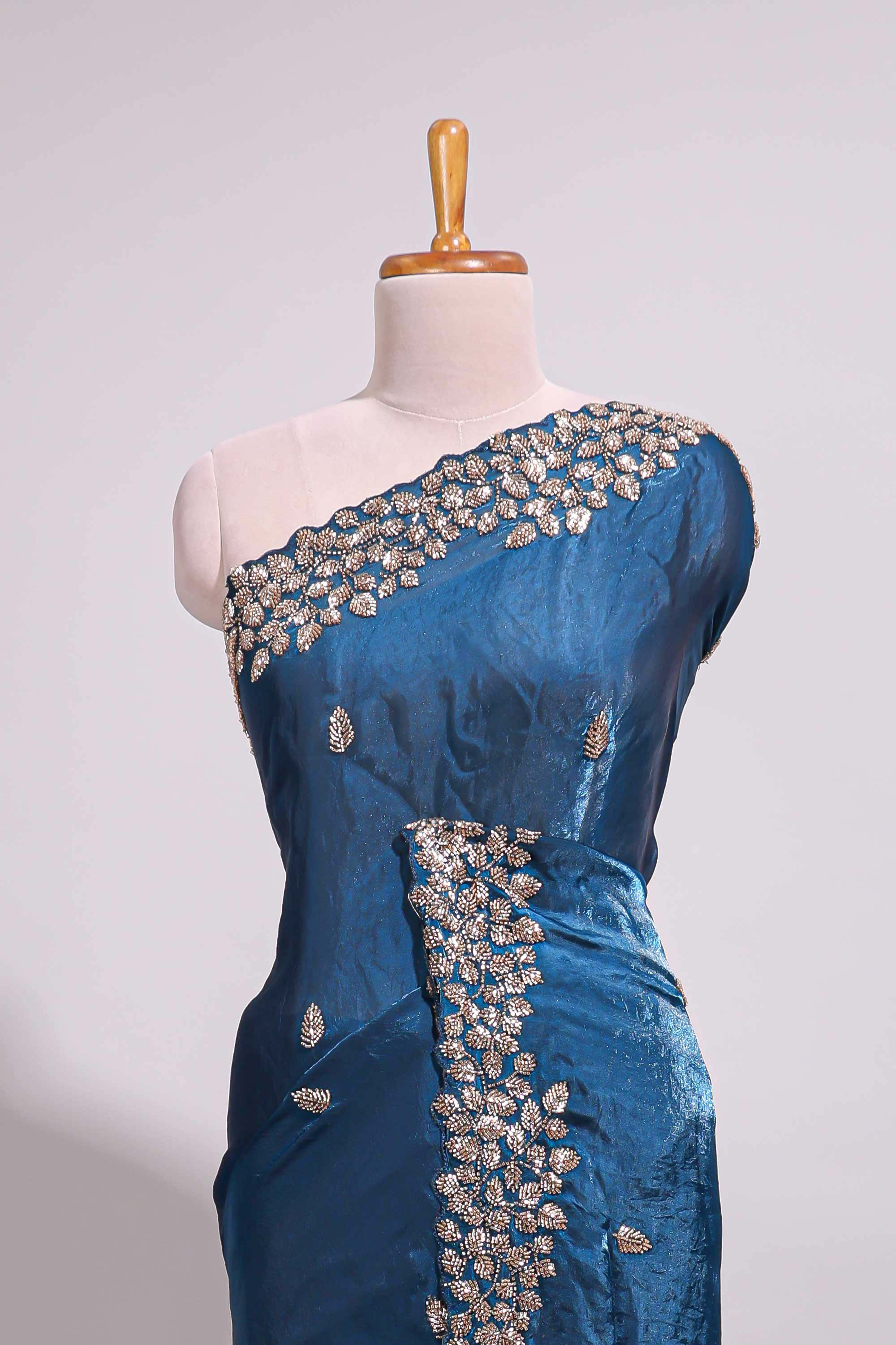 Royal blue saree with elegant golden floral embroidery and a rich embellished border along with embroidered blouse piece