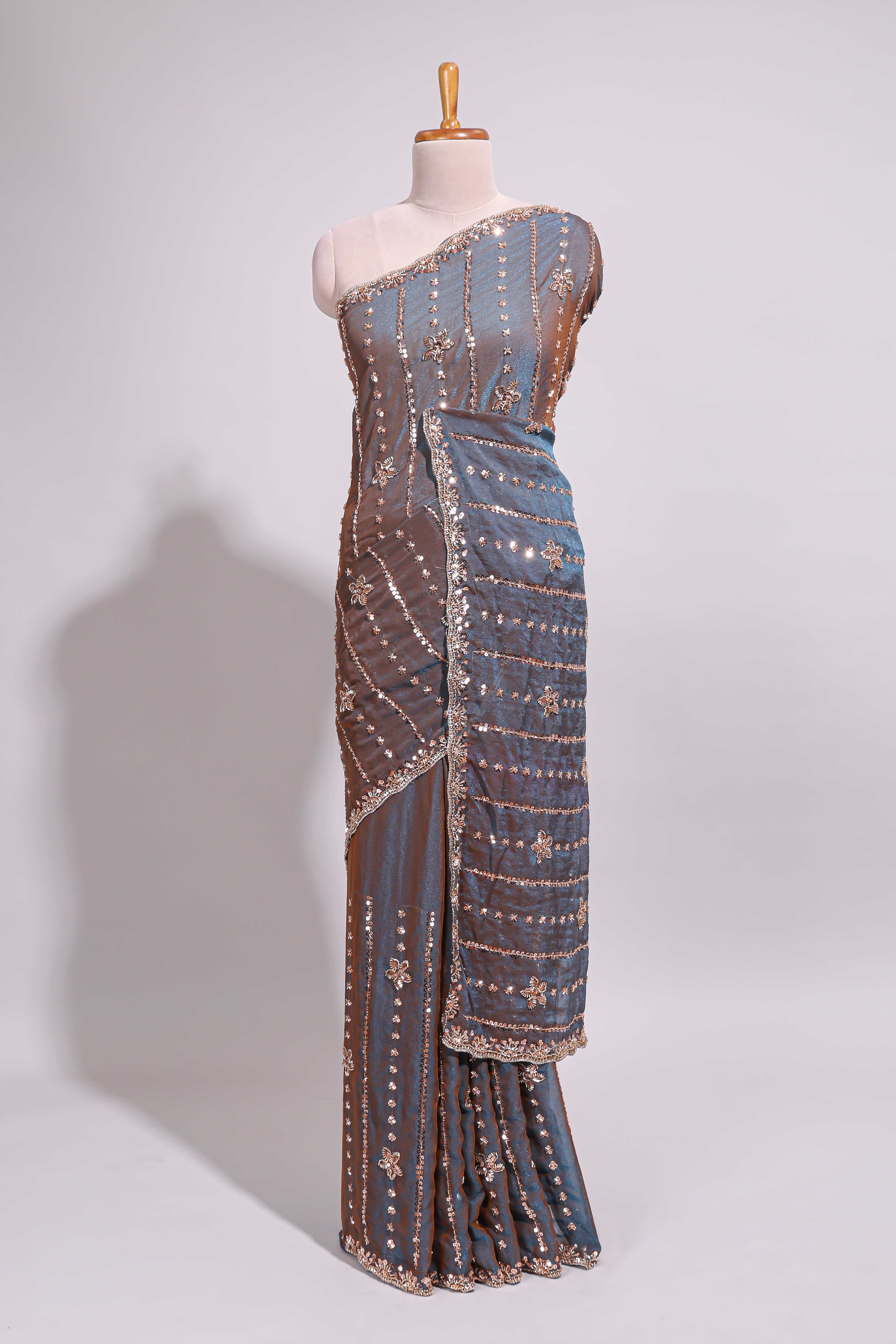 Steel blue saree with silver sequin floral motifs vertical stripe detailing and an embellished border along with blouse