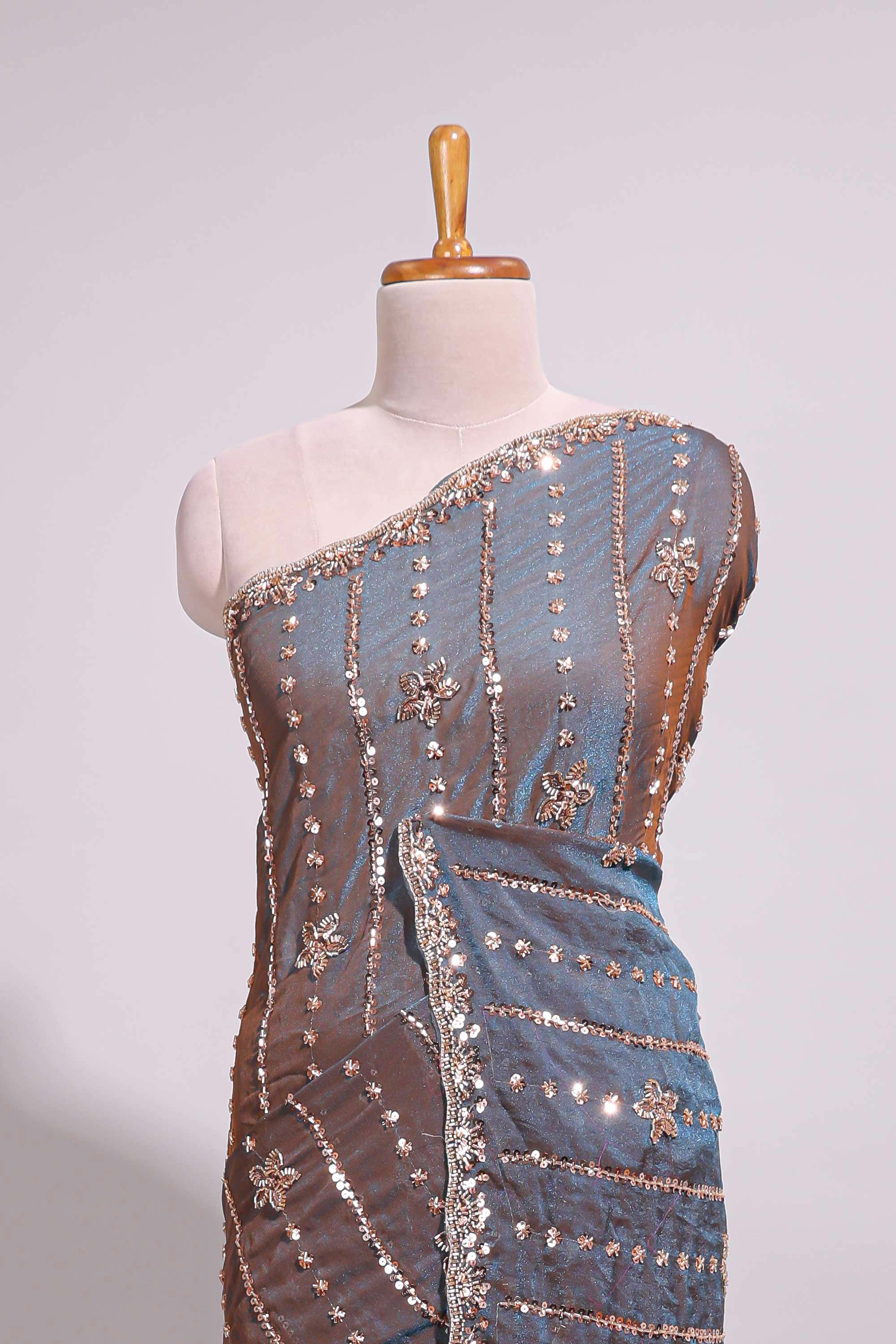 Steel blue saree with silver sequin floral motifs vertical stripe detailing and an embellished border along with blouse