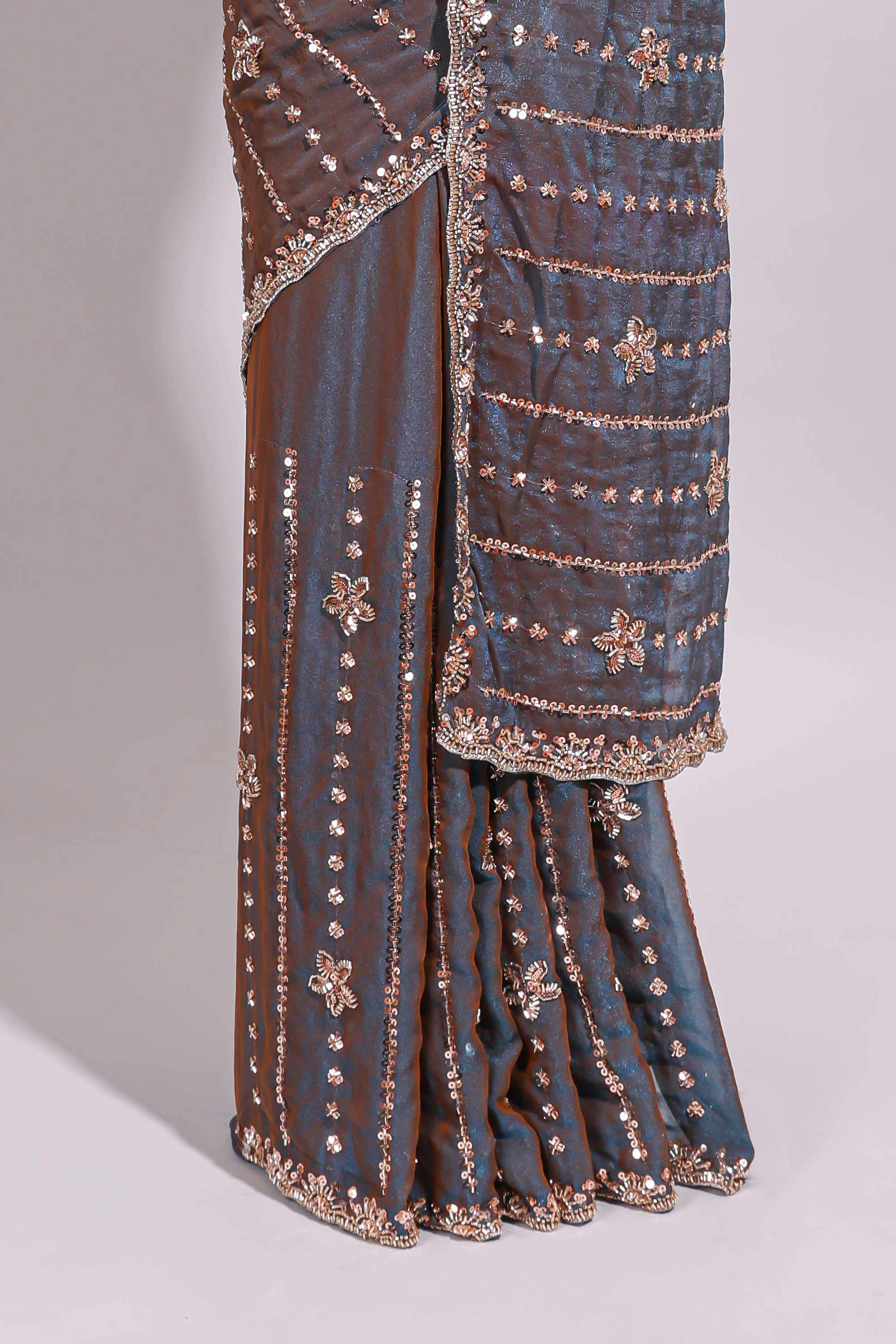 Steel blue saree with silver sequin floral motifs vertical stripe detailing and an embellished border along with blouse