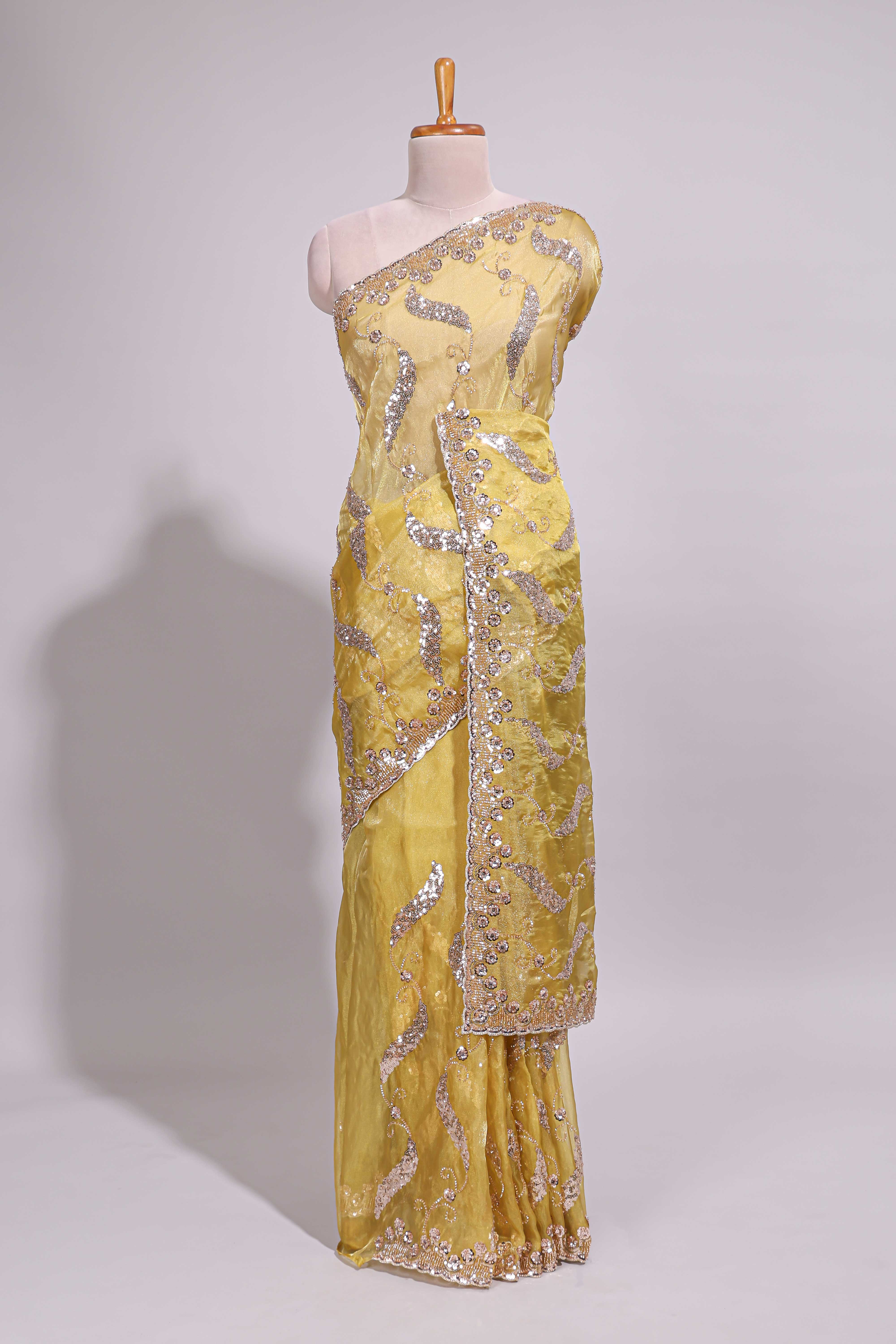Lemon yellow saree with silver sequin abstract embroidery floral motifs and a shimmering embellished border along with matching blouse