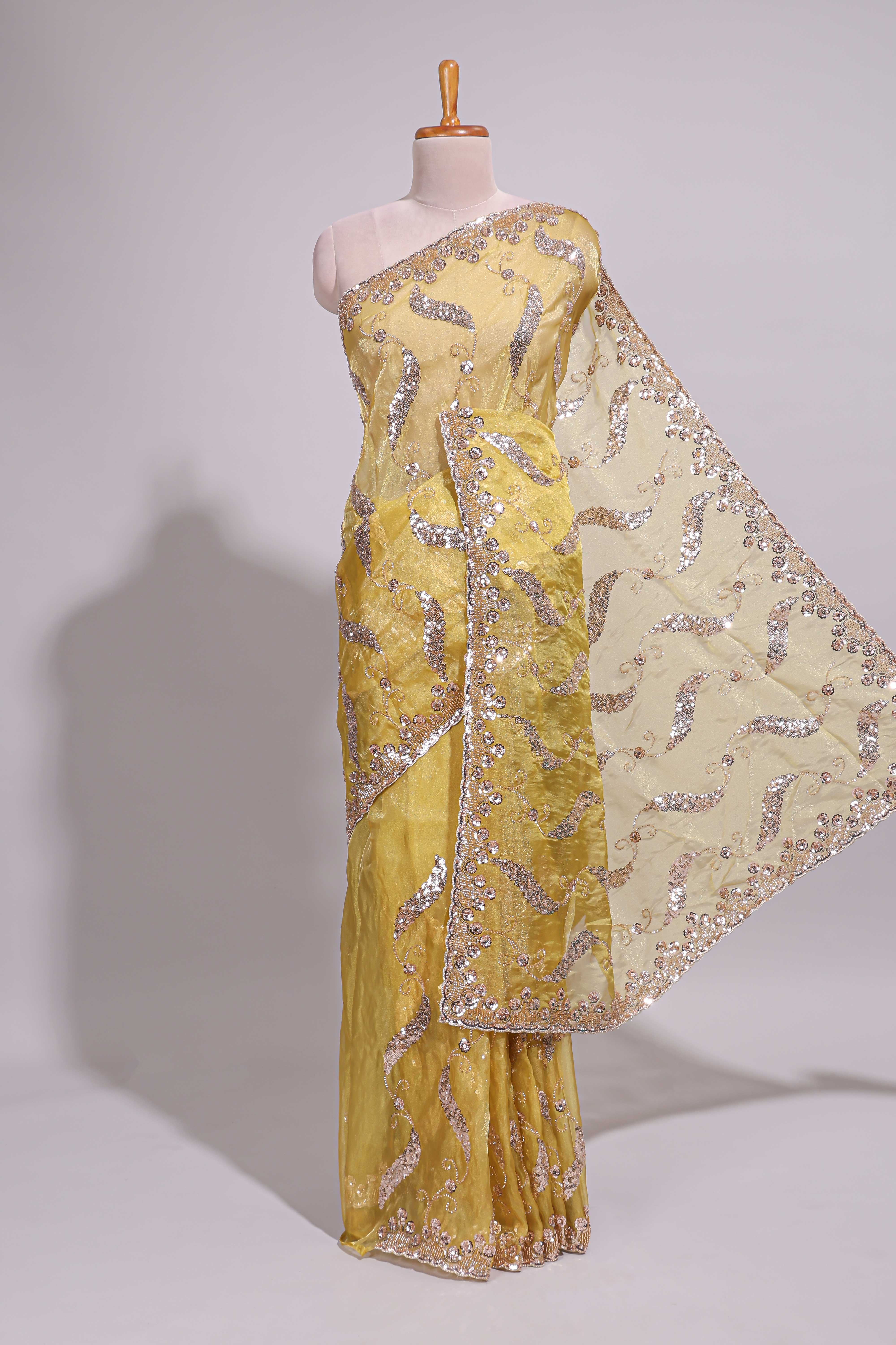 Lemon yellow saree with silver sequin abstract embroidery floral motifs and a shimmering embellished border along with matching blouse