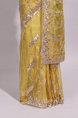 Lemon yellow saree with silver sequin abstract embroidery floral motifs and a shimmering embellished border along with matching blouse