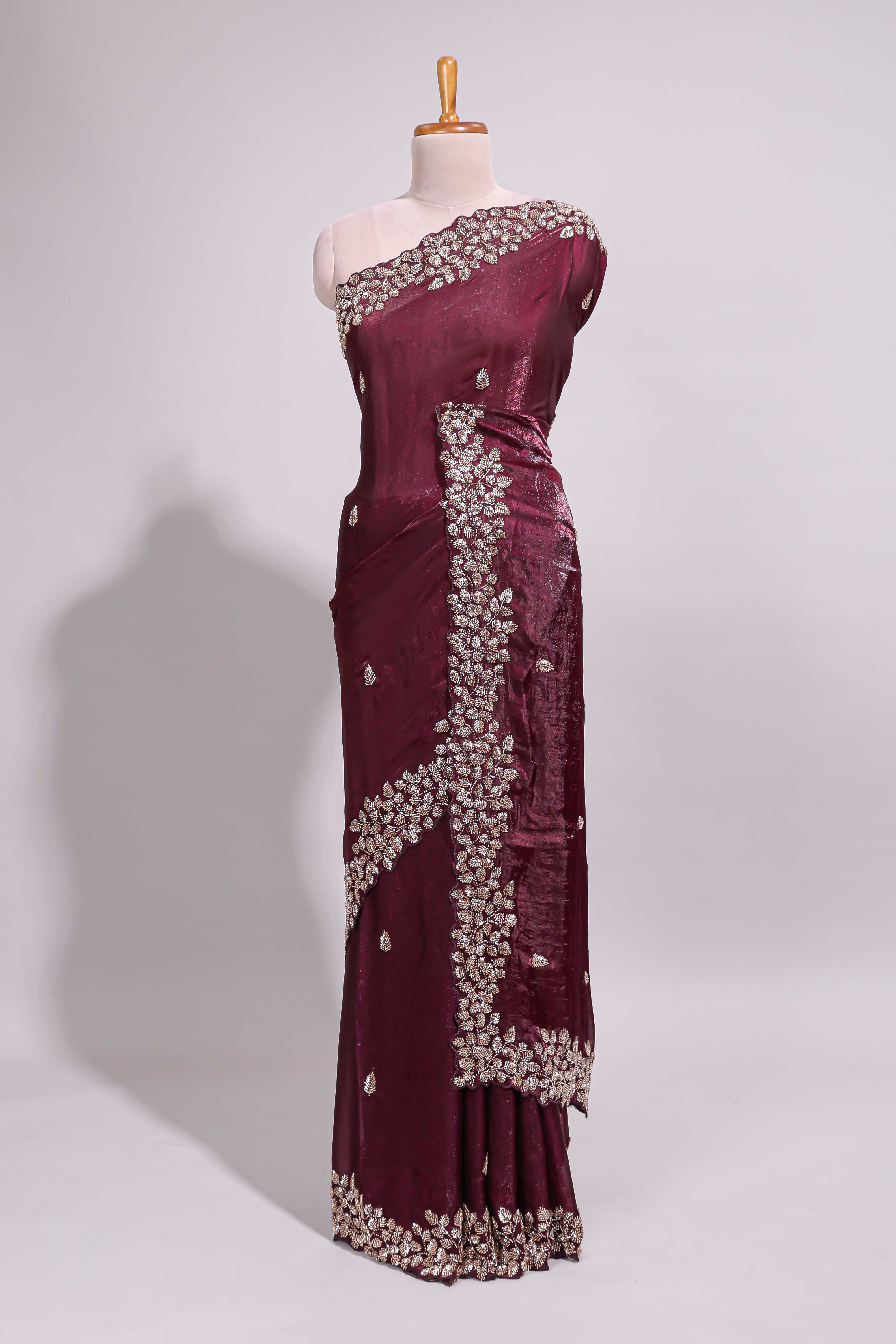Deep wine saree with elegant golden floral embroidery and a rich embellished border along with matching blouse