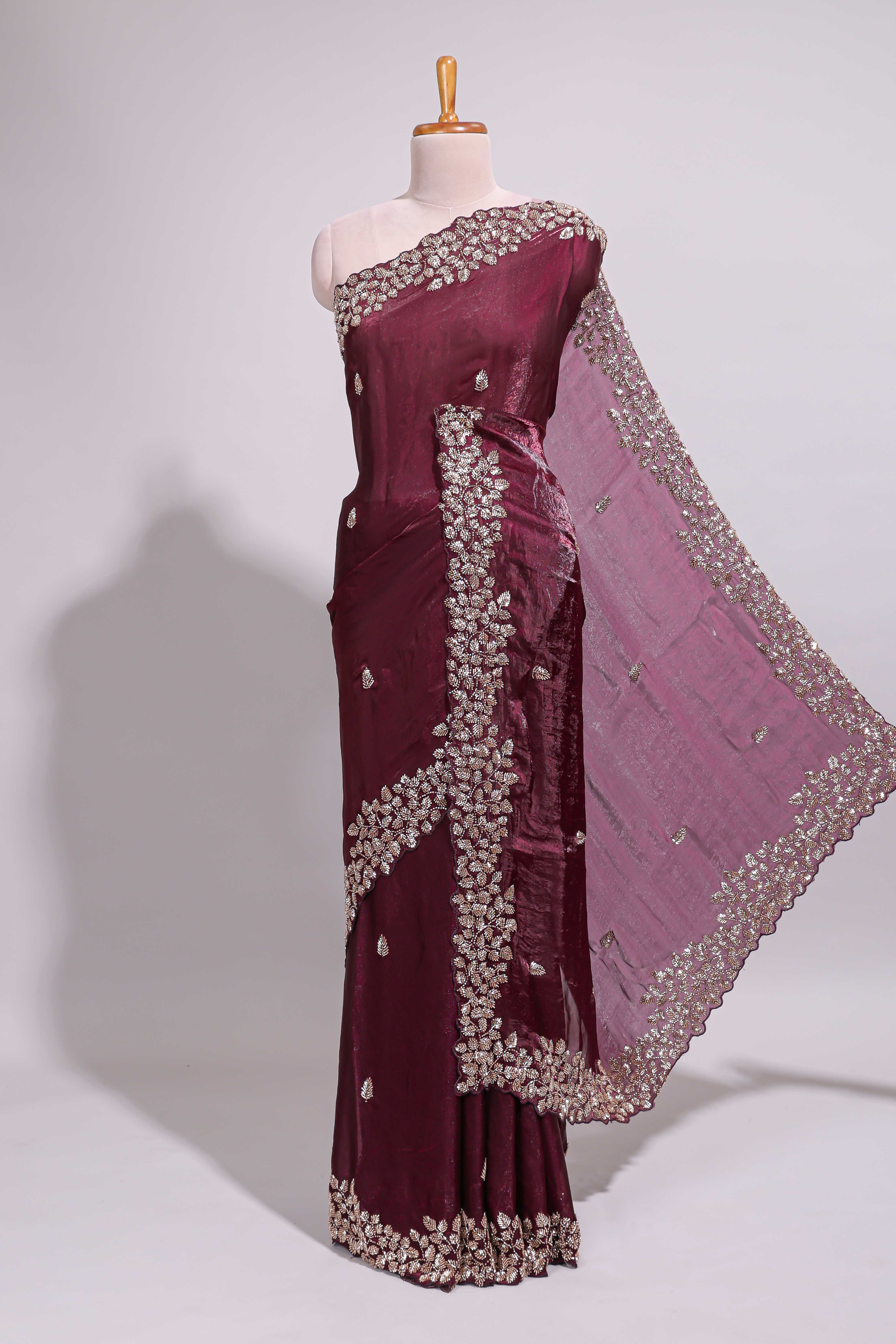 Deep wine saree with elegant golden floral embroidery and a rich embellished border along with matching blouse