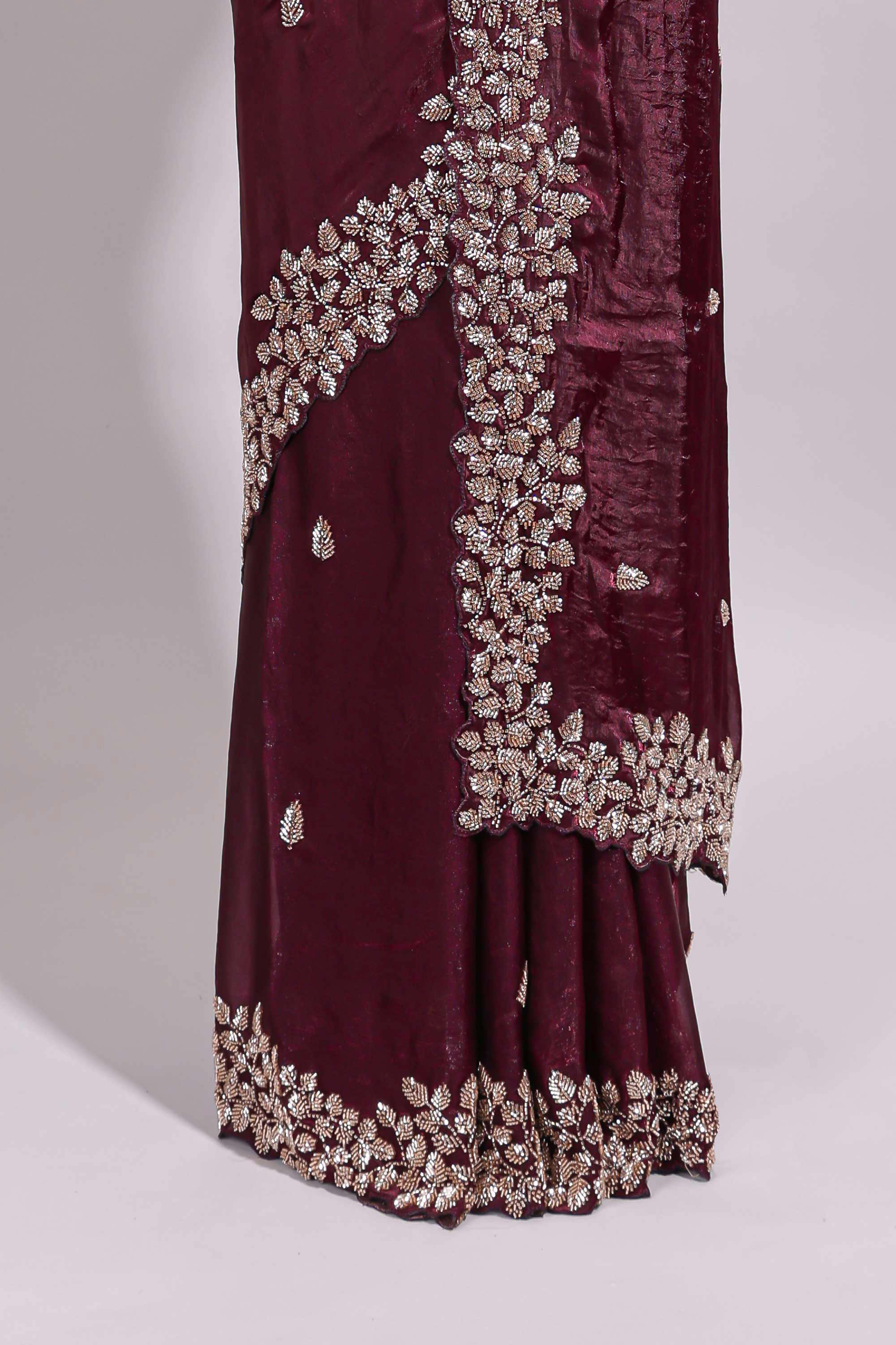 Deep wine saree with elegant golden floral embroidery and a rich embellished border along with matching blouse