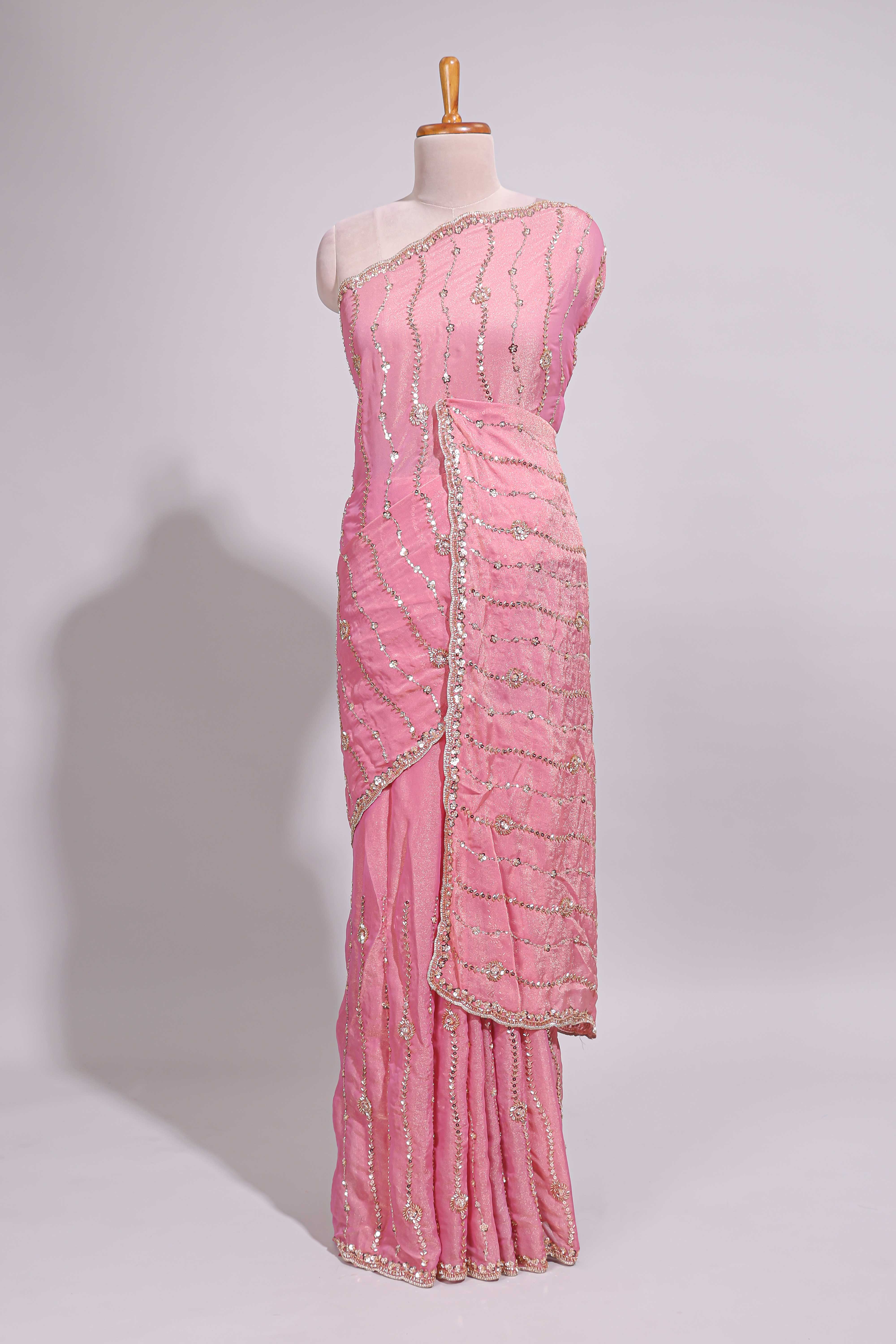 Baby pink saree with silver sequin wavy line embroidery floral motifs and a sparkling embellished border along with matching blouse