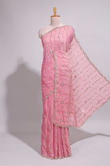 Baby pink saree with silver sequin wavy line embroidery floral motifs and a sparkling embellished border along with matching blouse